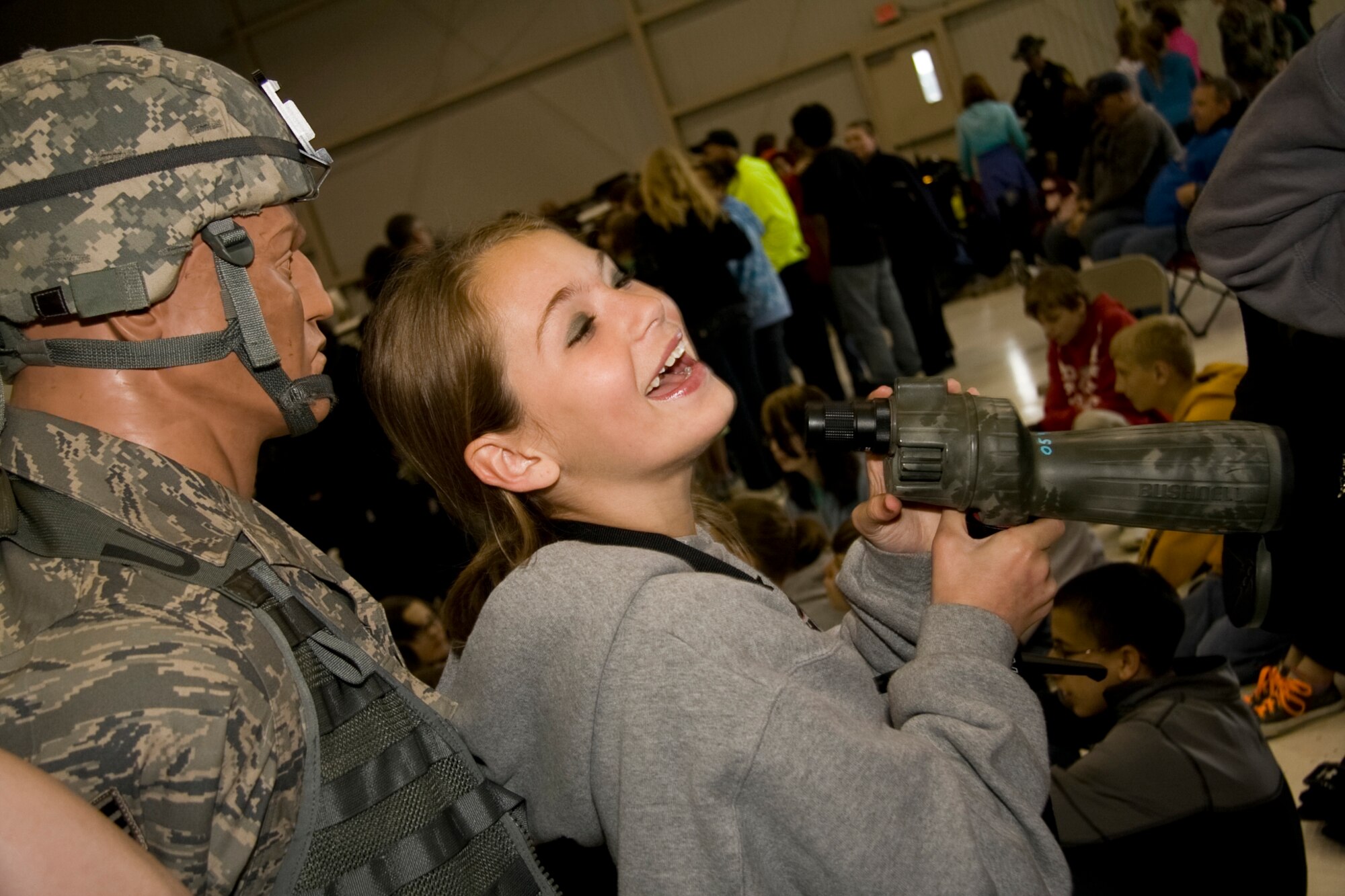 GRISSOM AIR RESERVE BASE, Ind. -- Laughing with friends, Megan Mongosa visits an information booth ran by the434th Security Forces Squadron during a National Police Week education day held here May 11. Ms. Mongosa, a sixth-grade student from North Miami Middle/High School, came with several hundred other kids from local-area schools to the event, which featured federal, state and local law enforcement agencies. National Police Week starts on May 9 and culminates with National Peace Officer Memorial Day on May 15. (U.S. Air Force photo/Tech. Sgt. Mark R. W. Orders-Woempner)