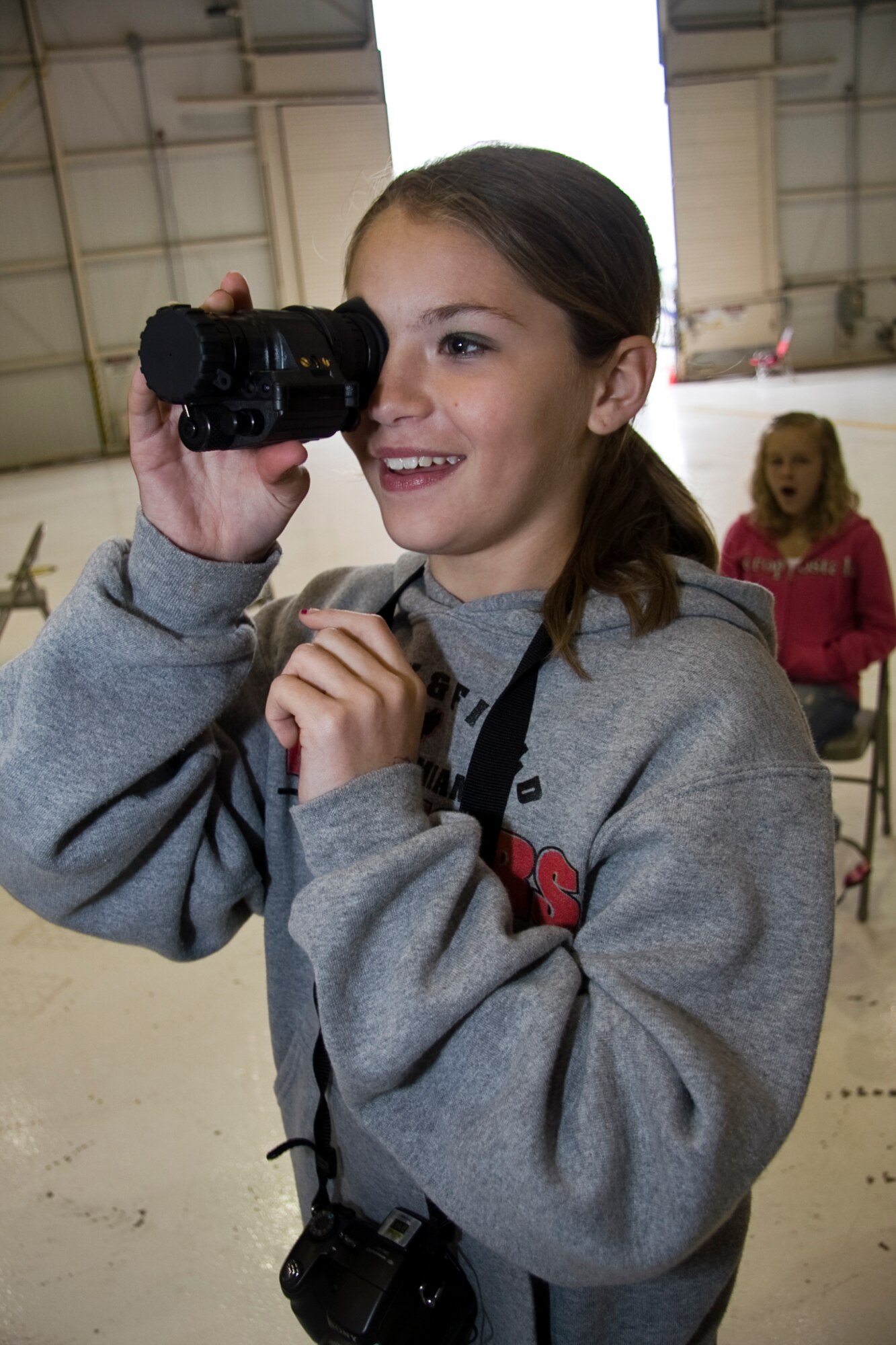 GRISSOM AIR RESERVE BASE, Ind. -- Megan Mongosa, a sixth-grade student from North Miami Middle/High School, looks through a night-vision monocular at a 434th Security Forces Squadron booth during a National Police Week education day held here May 11. Schools from the local area came to Grissom to take part in the event, which featured agencies such as the U.S. Marshall Service; the Federal Bureau of Investigation; 434th SFS, Department of Natural Resources; and the Peru, Miami County and Indiana State Police departments. National Police Week starts on May 9 and culminates with National Peace Officer Memorial Day on May 15. (U.S. Air Force photo/Tech. Sgt. Mark R. W. Orders-Woempner)