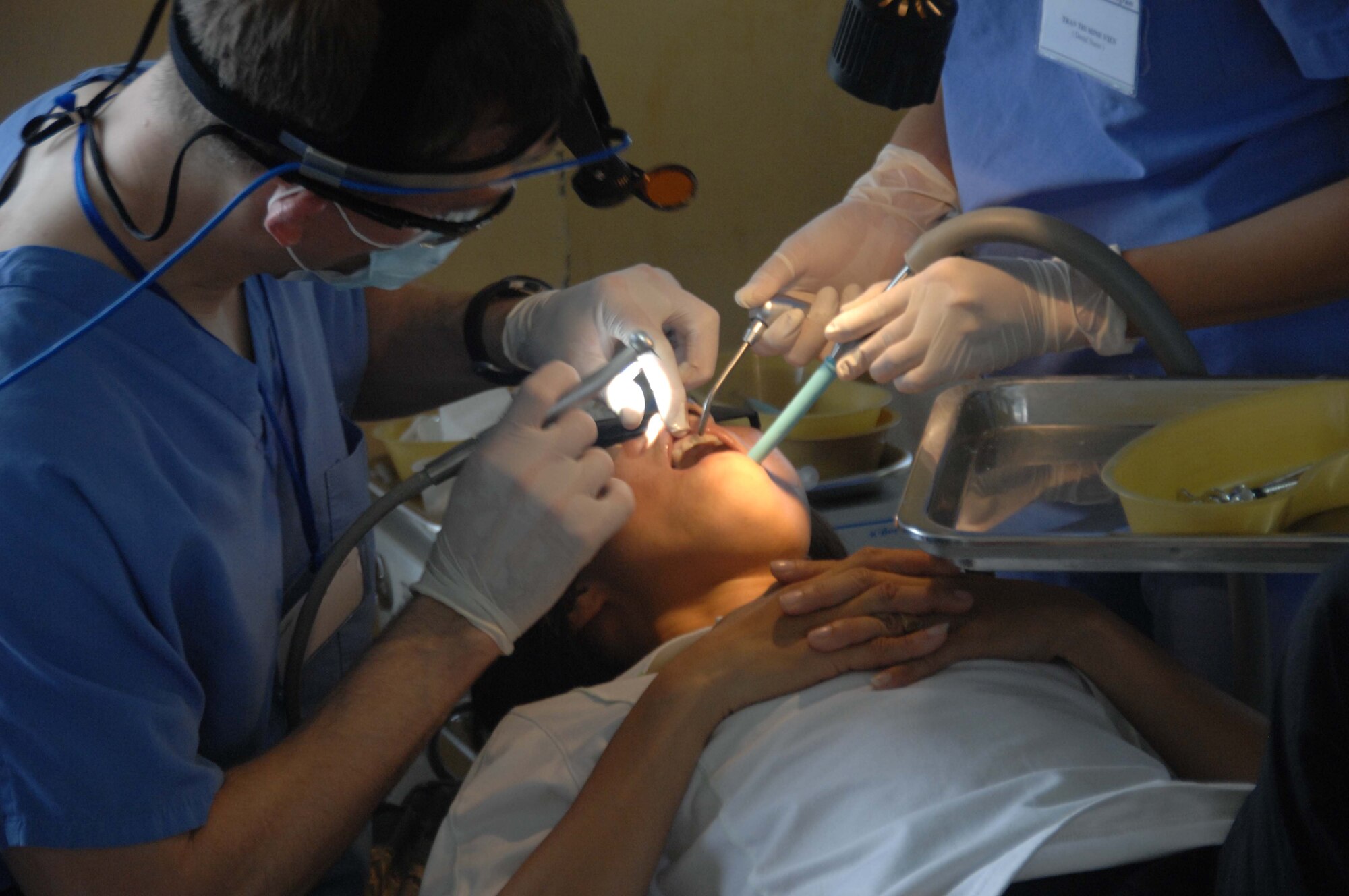 Dental work is performed on a local Vietnamese woman May 10, 2010, at the temporary medical clinic in Tan Thoi, Vietnam, as part of Pacific Angel 10-2.  Nearly 100 patients were seen in the dental clinic during the opening day. Pacific Angel is a joint and combined humanitarian and civic assistance operation conducted in the Pacific in support of U.S. Pacific Command's capacity building efforts.  (U.S. Air Force photo/Capt. Timothy Lundberg)