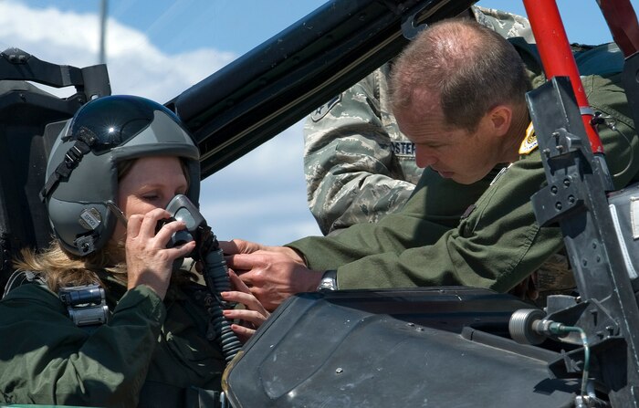 NELLIS AIR FORCE BASE, Nev. -- The Honorable Shari Buck, Mayor of North Las Vegas, receives assistance with her flight helmet from Lt. Col. Craig Jones, 706th Fighter Squadron commander, before their F-15E flight at the Nellis May 12. (U.S. Air Force Photo by Airman 1st Class Brett Clashman)
