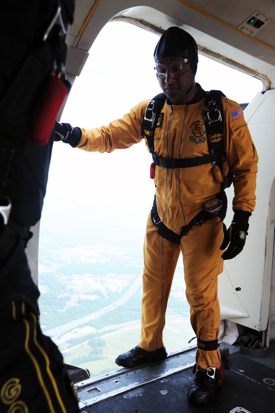 JOINT BASE ANDREWS, Md. – Army Sgt. 1st Class Arlyn Slade, Army Golden Knight, steps out of the C-31A Friendship aircraft during a tandem jump during the Joint Service Open House here May 14.  JSOH allows members of the public an excellent opportunity to meet and interact with the men and women of the Armed Forces and to show them America’s skilled military. (U.S. Air Force photo by Staff Sgt. Christopher A. Marasky)