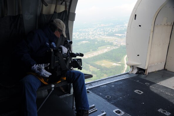 JOINT BASE ANDREWS, Md. – Vaness Kollhof, an ABC 7 News videographer, captures footage of the Andrews Air Show from aboard the C-31A Friendship, the Army Golden Knights aircraft, in the skies above the Joint Service Open House here May 14. JSOH allows members of the public an excellent opportunity to meet and interact with the men and women of the Armed Forces and to show them America’s skilled military.  (U.S. Air Force photo by Staff Sgt. Christopher A. Marasky)