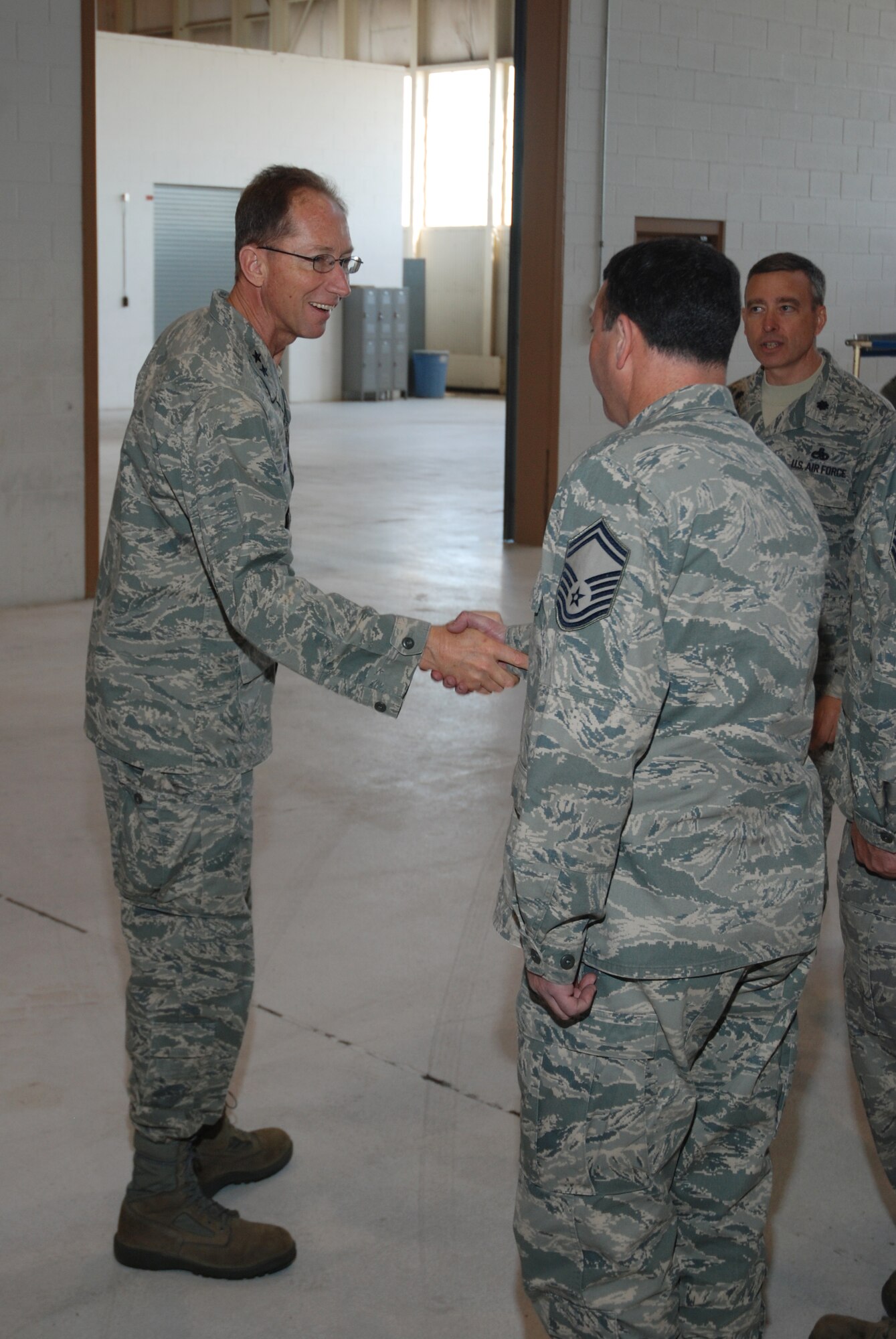 Members of the 439th Maintenance Squadron greet Maj. Gen. James T. Rubeor, the 22nd Air Force commander, during his visit to the Isochronal Inspection Dock at Westover May 12 and 13.  
