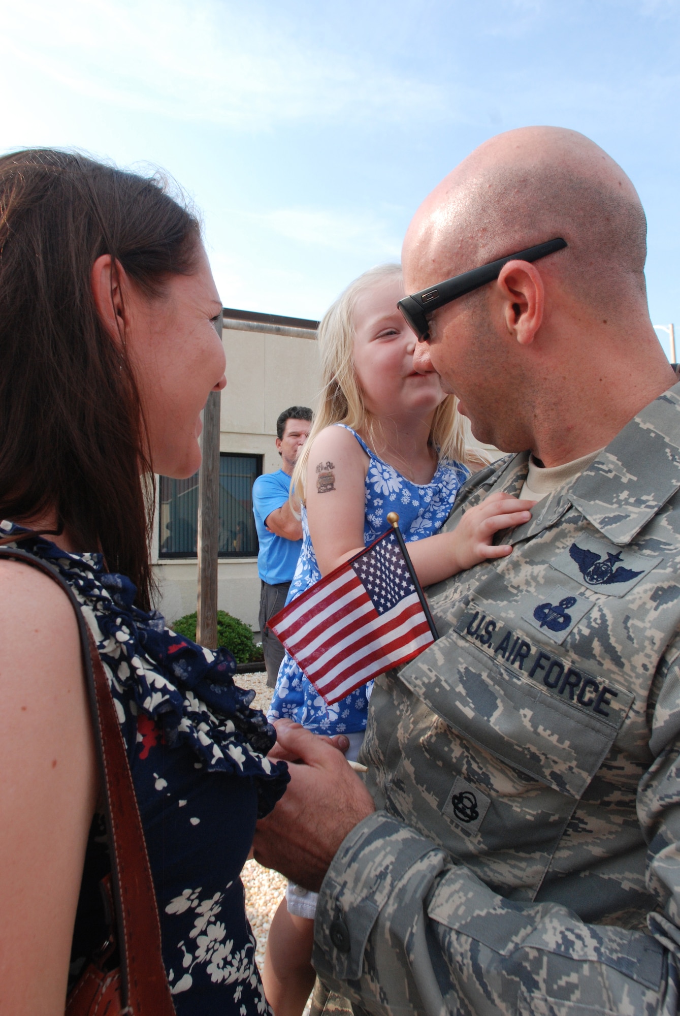 PATRICK AIR FORCE BASE, Fla. -  Tech. Sgt. Wes Hufnagel, reserve pararescueman, is welcomed home with big smiles from his three year-old daughter, Lola, as his wife, Sheri, watches. Sgt. Hufnagel was deployed in support of Operation Enduring Freedom and spent two months overseas. The reserve PJs are specifically trained in all aspects of combat search and rescue and are able to perform life-saving missions all over the world and in remote locations. (U.S. Air Force photo/Staff Sgt. Leslie Kraushaar)