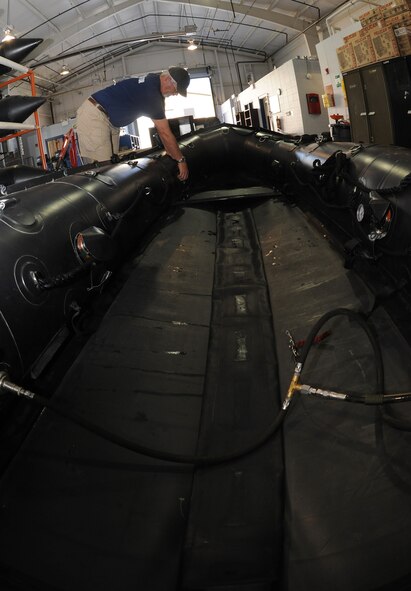 MOODY AIR FORCE BASE, Ga. -- Pat Sinon, 38th Rescue Squadron logistics flight boat master, cleans an F-470 Zodiac inflatable boat after a water training exercise here May 12. The Zodiac inflatable boat is used for water operations by the 38th RQS. (U.S. Air Force photo by Airman 1st Class Benjamin Wiseman/RELEASED)