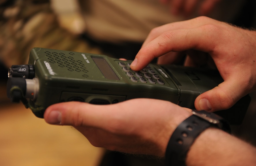 MOODY AIR FORCE BASE, Ga. -- Senior Airman Jacob Manee, 38th Rescue Squadron logistics flight communications, sets up a personal radio for a 38th RQS pararescueman here May 12. The AN/PRC-152 radio is used by the 38th RQS to communicate between members and also nearby air support during operations. (U.S. Air Force photo by Airman 1st Class Benjamin Wiseman/RELEASED)
