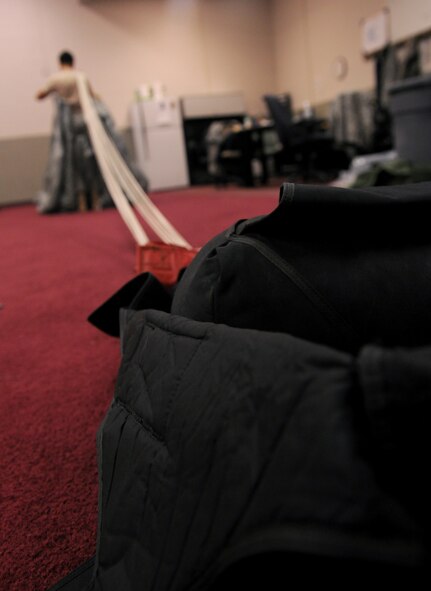 MOODY AIR FORCE BASE, Ga. -- Senior Airman Andrea Brandenberg, 38th Rescue Squadron logistics flight aircrew flight equipment journeyman, starts to fold a free-fall parachute to be packed here May 10. The AFE section of the 38th RQS works with the parachutes, oxygen equipment, cargo bundles and dive equipment to ensure that all equipment is working before sending it out on a mission. (U.S. Air Force photo by Airman 1st Class Benjamin Wiseman/RELEASED)