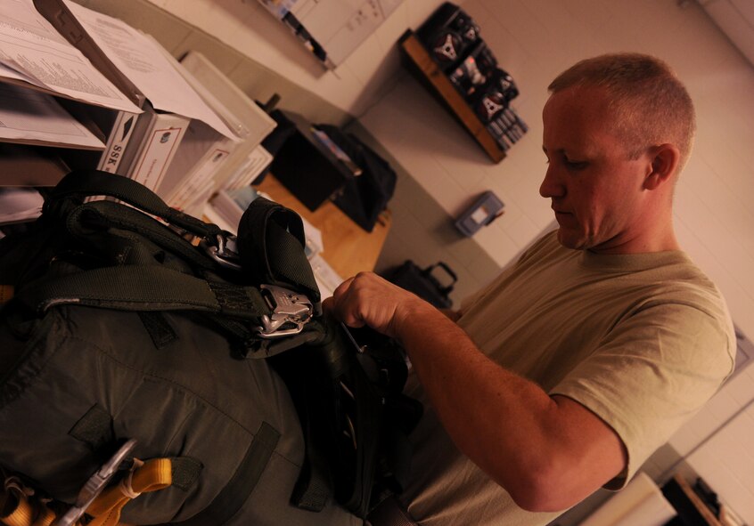 MOODY AIR FORCE BASE, Ga. -- Staff Sgt. Clifford Sisk, 38th Rescue Squadron logistics flight aircrew flight equipment craftsman, inspects a special operations vector parachute here May 10. Each parachute packed by the 38th RQS logistics flight is inspected and approved before being used for a mission. (U.S. Air Force photo by Airman 1st Class Benjamin Wiseman/RELEASED)