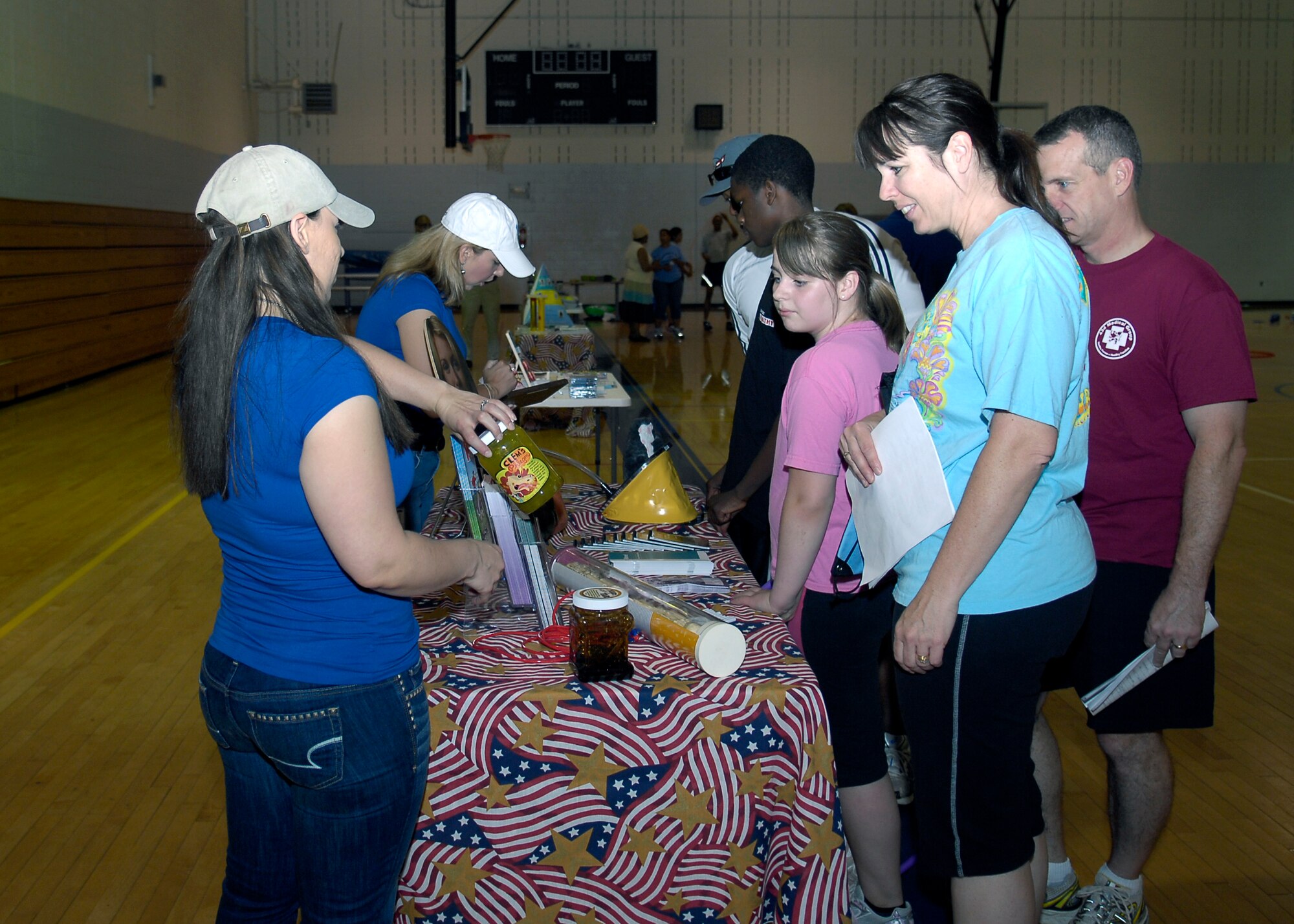 Team Pope members and their families gather around one of many of the information stands provided to participants in the Fit Family Health Fair at the Pope Fitness Center on May 8. The information stands provided information on several health related issues such as smoking, unhealthy snacking and proper nutrition. (U.S. Air Force photo/Senior Airman Kris Levasseur)