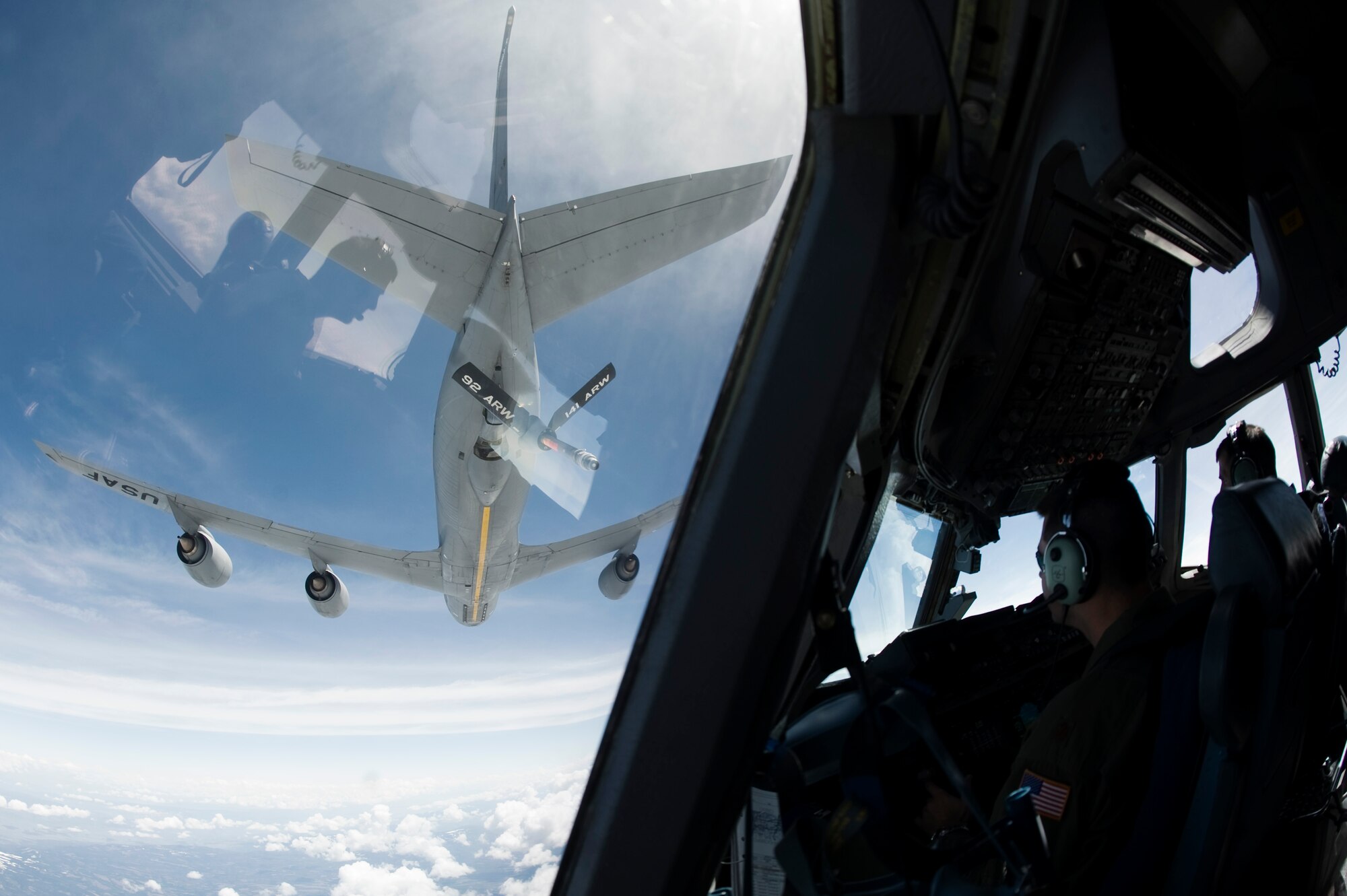 Majs. Joshua Ellis, left, and Daniel Dobbels, 62nd Airlift Wing, prepare to receive fuel from a KC-135 Stratotanker from Fairchild Air Force Base, Wash., during an in-flight refueling mission May 12.   Aircews participated in a seven-ship formation as part of a joint requirement to execute Army forcible entry operations by airdropping an entire brigade on short notice.(U.S. Air Force Photo by Abner Guzman)

