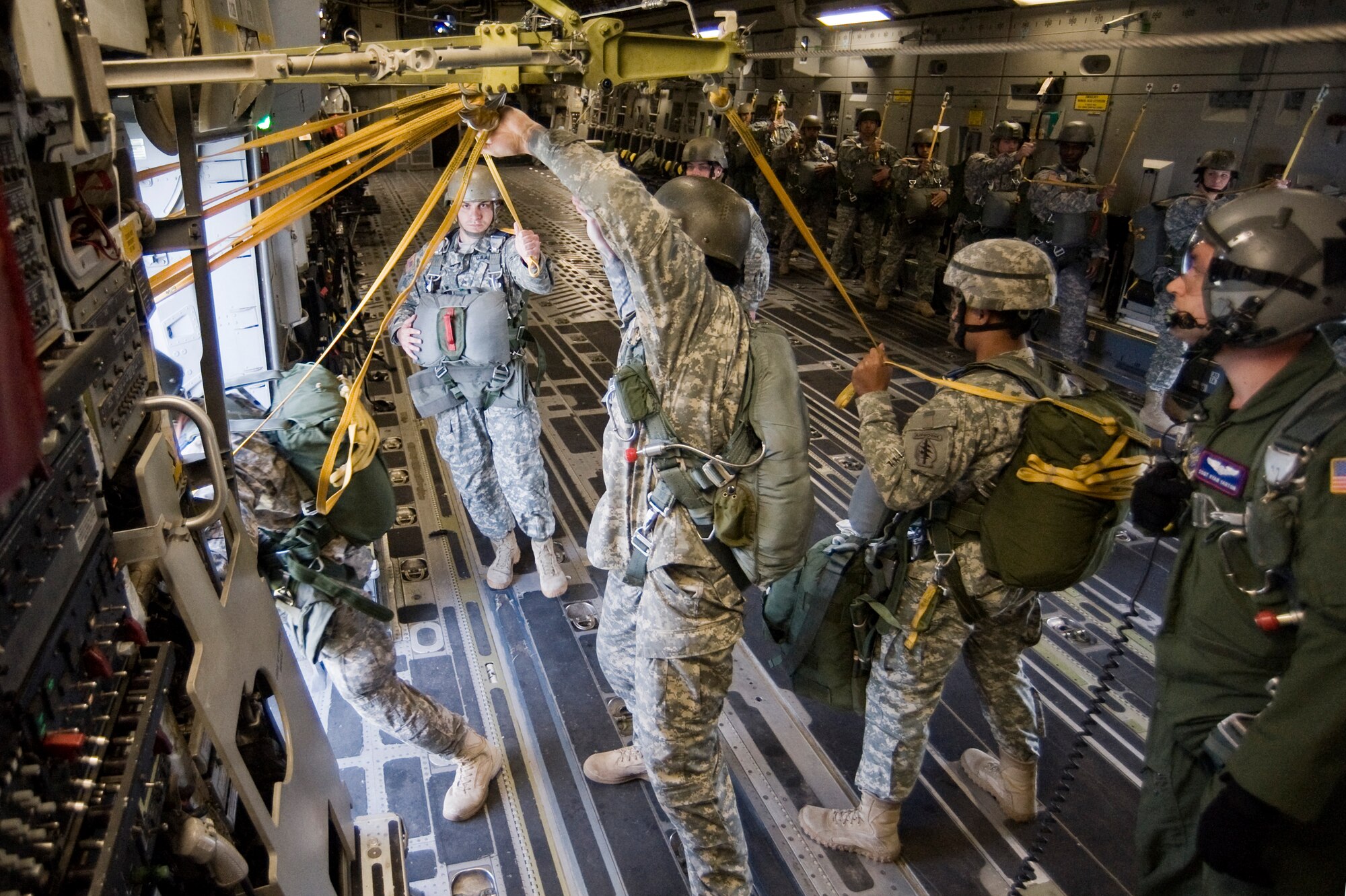 Staff Sgt. Ryan Yarton, 4th Airlift Squadron, right, looks on as Soldiers from the 1st Special Forces Group, Joint Base Lewis-McChord, exit the troop door of a C-17 Globemaster III as part of a joint exercise May 12. (U.S. Air Force Photo by Abner Guzman)

