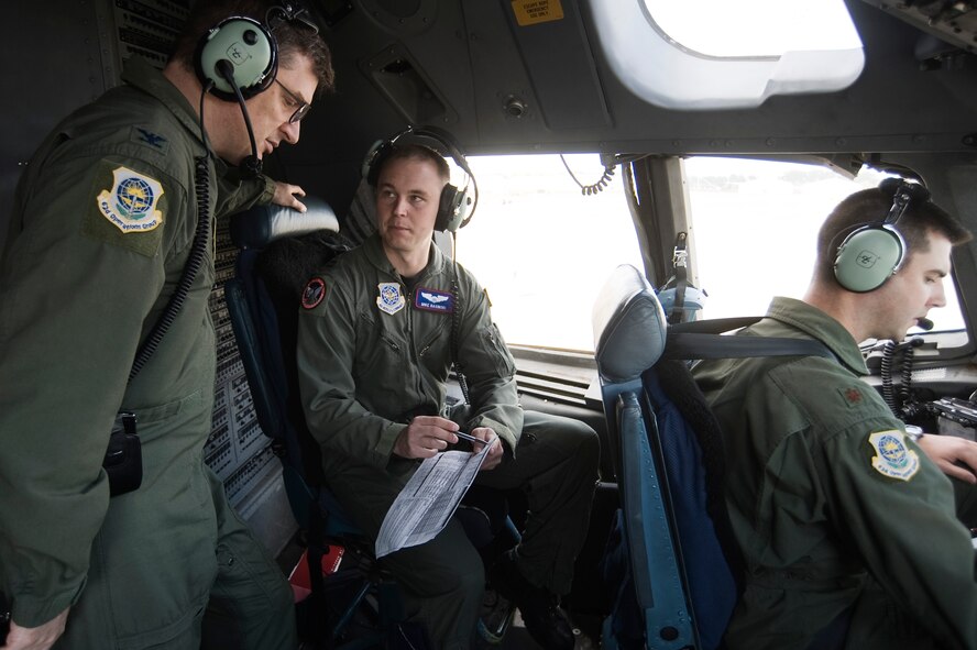 Col. Glenn Rousseau, 62nd Operations Group commander, left, and Capt. Michael Rasinski, 4th Airlift Squadron, discuss launching procedures on the flight-deck of a C-17 Globemaster III May 12. (U.S. Air Force Photo by Abner Guzman)

