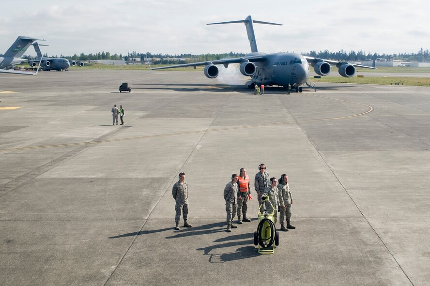 Aircraft maintainers assigned to the 62nd Aircarft Maintenance Squadron wait to launch several C-17 Globemaster III's from McChord Field May 12. (U.S. Air Force Photo by Abner Guzman)

