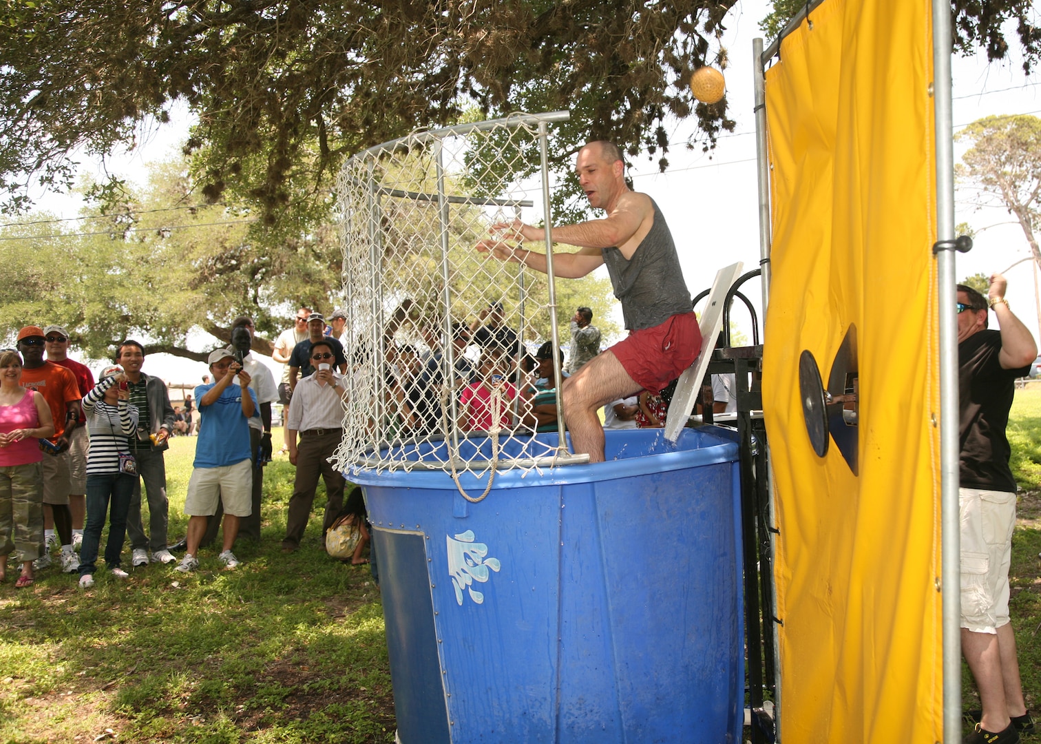 Col. Howard Jones III, Defense Language Institute English Learning Center commandant, takes a plunge in the dunking booth May 7 at the annual DLIELC picnic. Colonel Jones is responsible for providing on-campus English language training to military and civilian leaders from over 110 countries, and overseeing English language training at 30 overseas nonresident locations around the world. (U.S. Air Force photo/Robbin Cresswell)