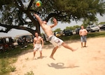 A group of DLIELC students take to the sand volleyball court the DLIELC picnic at Stillman Park May 7. The institute works to increase students' physical fitness through activities such as those found at the annual picnic, including soccer, a tug-of-war tournament and a hula hoop competition. The DLIELC student body is made up of attendees from the U.S., Puerto Rico and countries such as Korea, China, Turkey, Bangladesh and Russia, among others. An estimated 650 people attended the picnic. (U.S. Air Force photo/Robbin Cresswell)