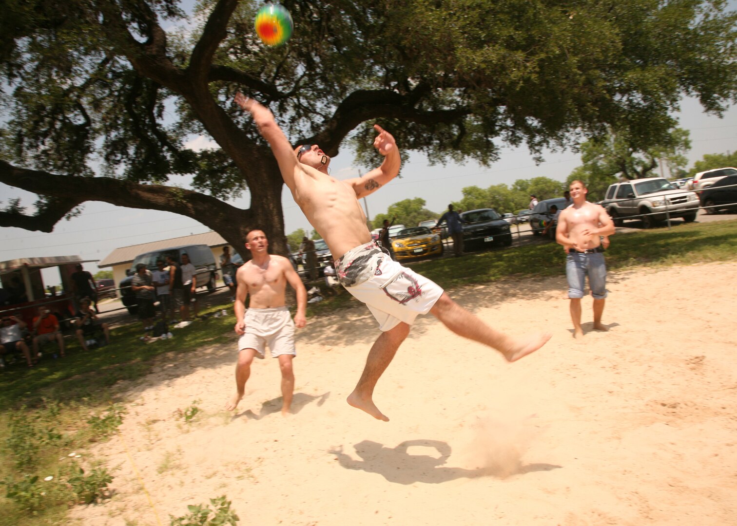 A group of DLIELC students take to the sand volleyball court the DLIELC picnic at Stillman Park May 7. The institute works to increase students' physical fitness through activities such as those found at the annual picnic, including soccer, a tug-of-war tournament and a hula hoop competition. The DLIELC student body is made up of attendees from the U.S., Puerto Rico and countries such as Korea, China, Turkey, Bangladesh and Russia, among others. An estimated 650 people attended the picnic. (U.S. Air Force photo/Robbin Cresswell)