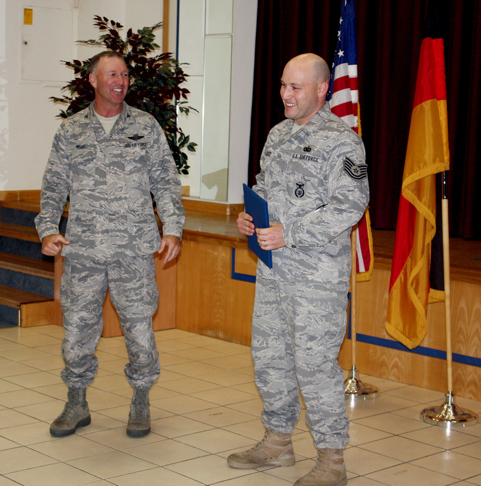 SPANGDAHLEM AIR BASE, Germany -- Col. Tip Wight, 52nd Fighter Wing commander, STEP-promotes Tech. Sgt. David Kechter Jr., 702nd Munitions Maintenance Squadron combat arms and equipment NCO in charge, May 12 at Buechel Air Base. Colonel Wight surprised 702nd MUNSS Airmen by showing up at their exercise hot wash and calling Sergeant Kechter up front for being "out of uniform." He then presented him technical sergeant stripes. (U.S. Air Force photo/Senior Master Sgt. Tammy Robel)