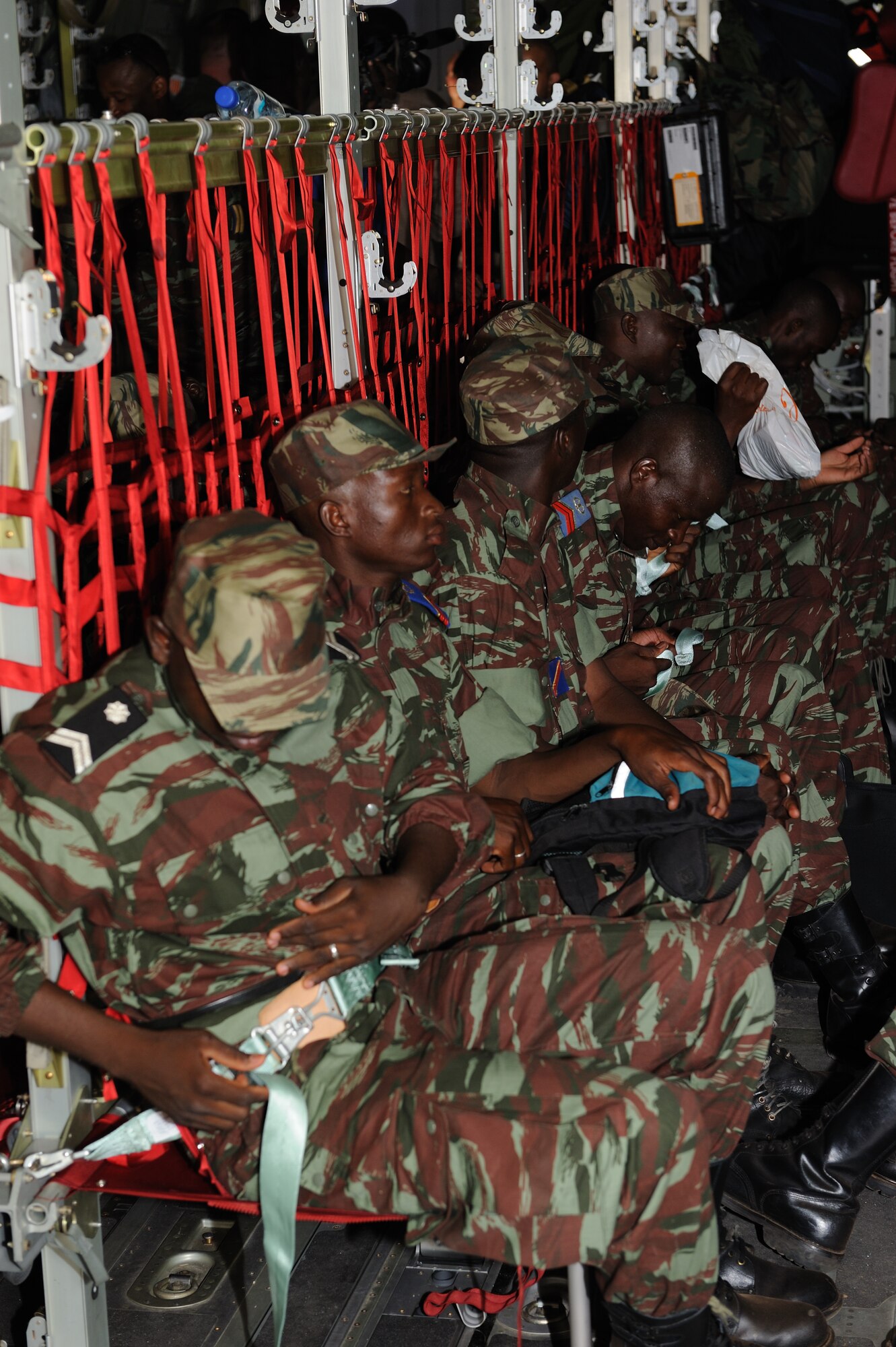 OUAGADOUGOU, Burkina Faso -- Burkinabe Army soldiers buckle themselves into a Ramstein Air Base C-130J “Super” Hercules May 1, 2010 to begin their deployment to Mali in support of Exercise Flintlock 10.  An element of about 40 soldiers boarded the C-130J to deploy for counter-terrorism training with U.S., Malian and European partners.  Flintlock 10 is a special operations forces exercise focused on military interoperability and capacity-building and is part of a U.S. Africa Command sponsored annual exercise program with partner nations in Northern and Western Africa.  The exercise, which includes participation of key European nations, is conducted by Special Operations Command Africa and designed to build relationships and develop capacity among security forces throughout the Trans-Saharan region of Africa.  Approximately 1,200 European, African Partner Nation and U.S. participants from 14 nations are involved in military interoperability activities across the Trans-Saharan region during this event.  (U.S. Air Force photo by Master Sgt. Jeremiah Erickson) 