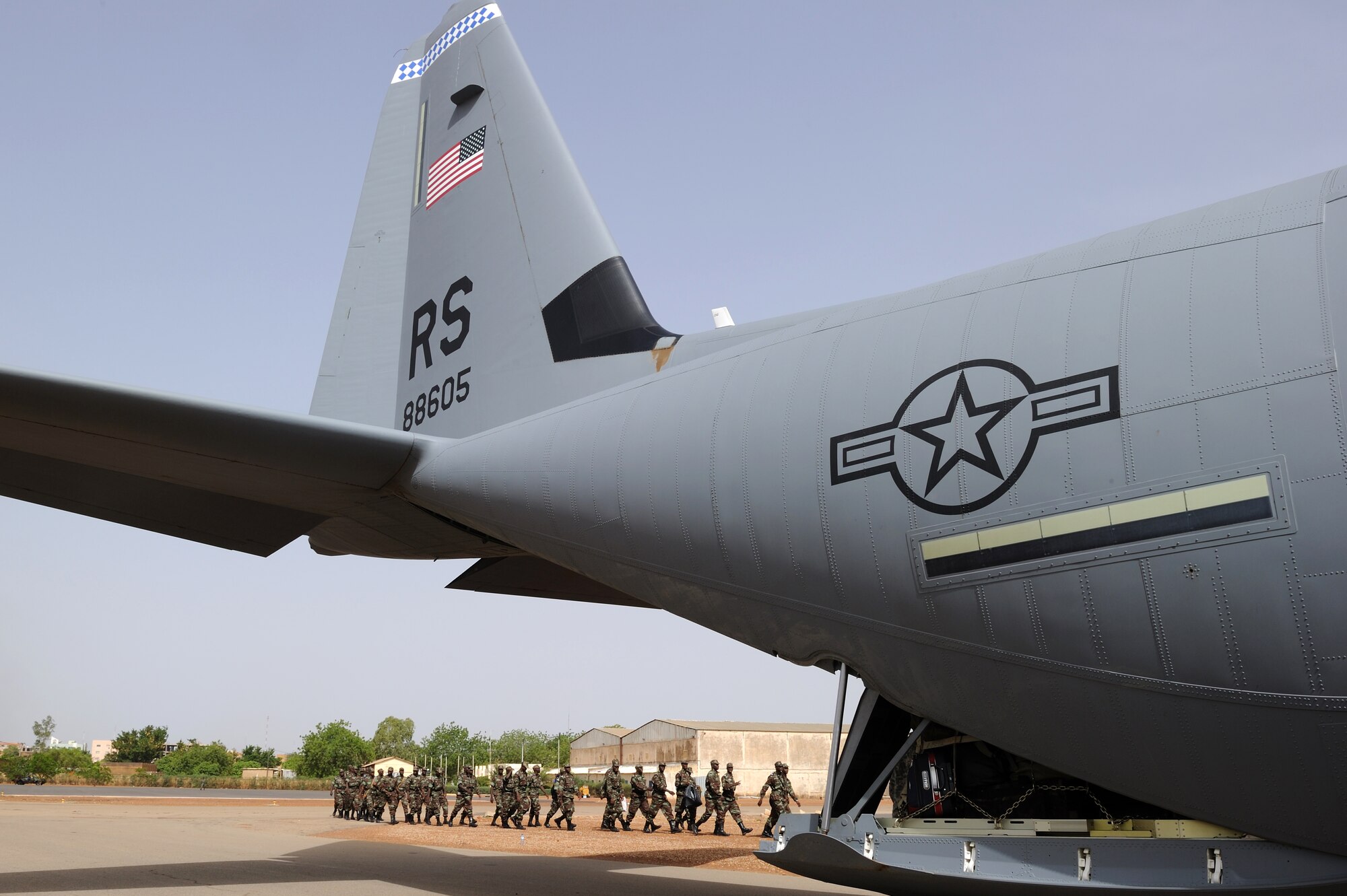 OUAGADOUGOU, Burkina Faso -- Burkinabe Army soldiers march toward a Ramstein Air Base C-130J Super Hercules May 1, to begin their deployment to Mali in support of Exercise Flintlock 10.  An element of about 40 soldiers boarded the C-130J to deploy for counter-terrorism training with U.S., Malian and European partners.  Flintlock 10 is an exercise focused on military interoperability and capacity-building and is part of a U.S. Africa Command sponsored annual exercise program with partner nations in Northern and Western Africa.  Approximately 1,200 African, European and U.S. participants from 14 nations are involved in military interoperability activities across the Trans-Saharan region during this event.  (U.S. Air Force photo by Master Sgt. Jeremiah Erickson) 