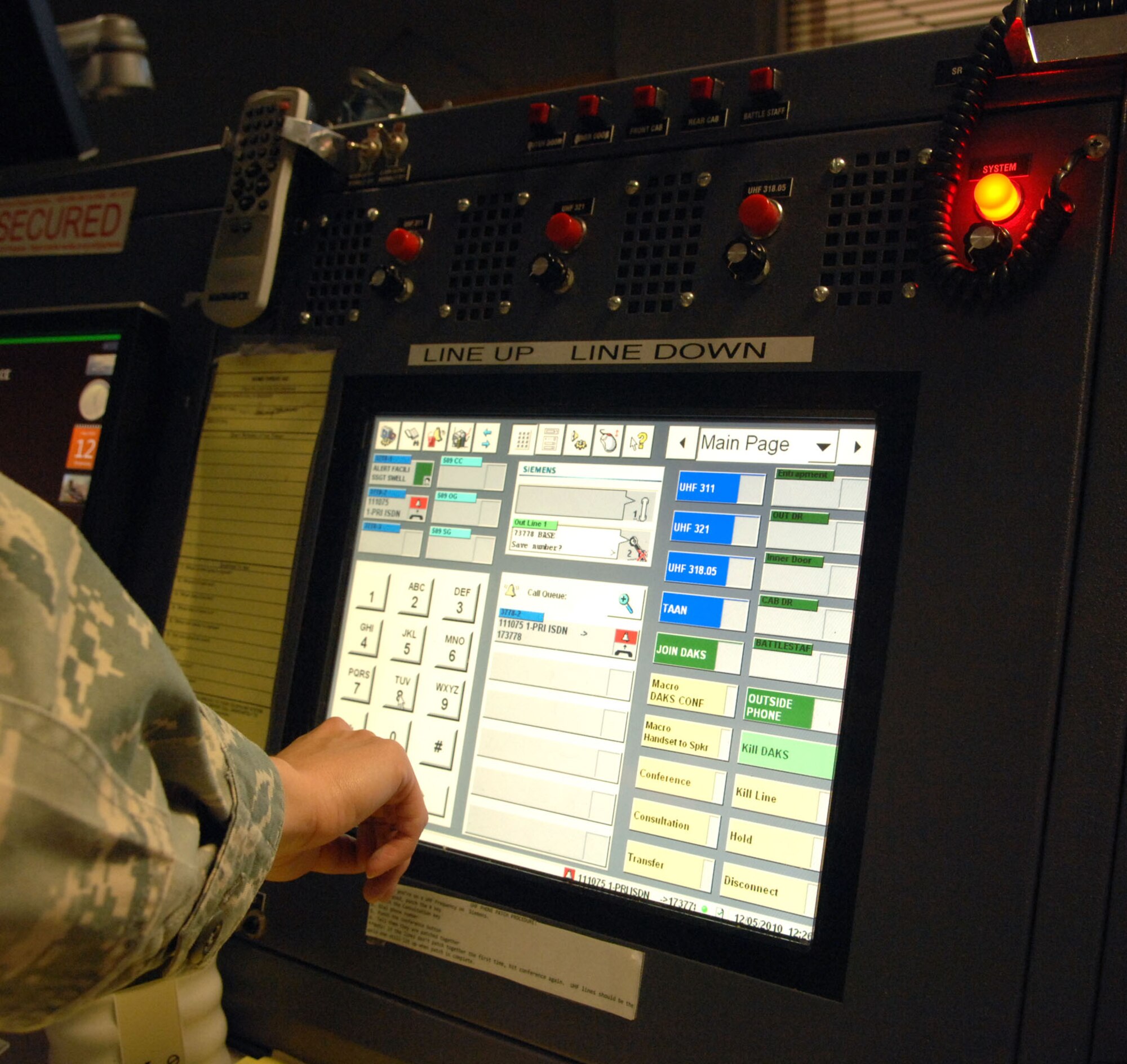 Tech. Sgt. Daniella Benson, senior emergency actions controller, relays information via the command post communication equipment.  Command post controllers are eyes and ears for the commander, and handle situations that could range from domestic disputes to Aircraft crashes.