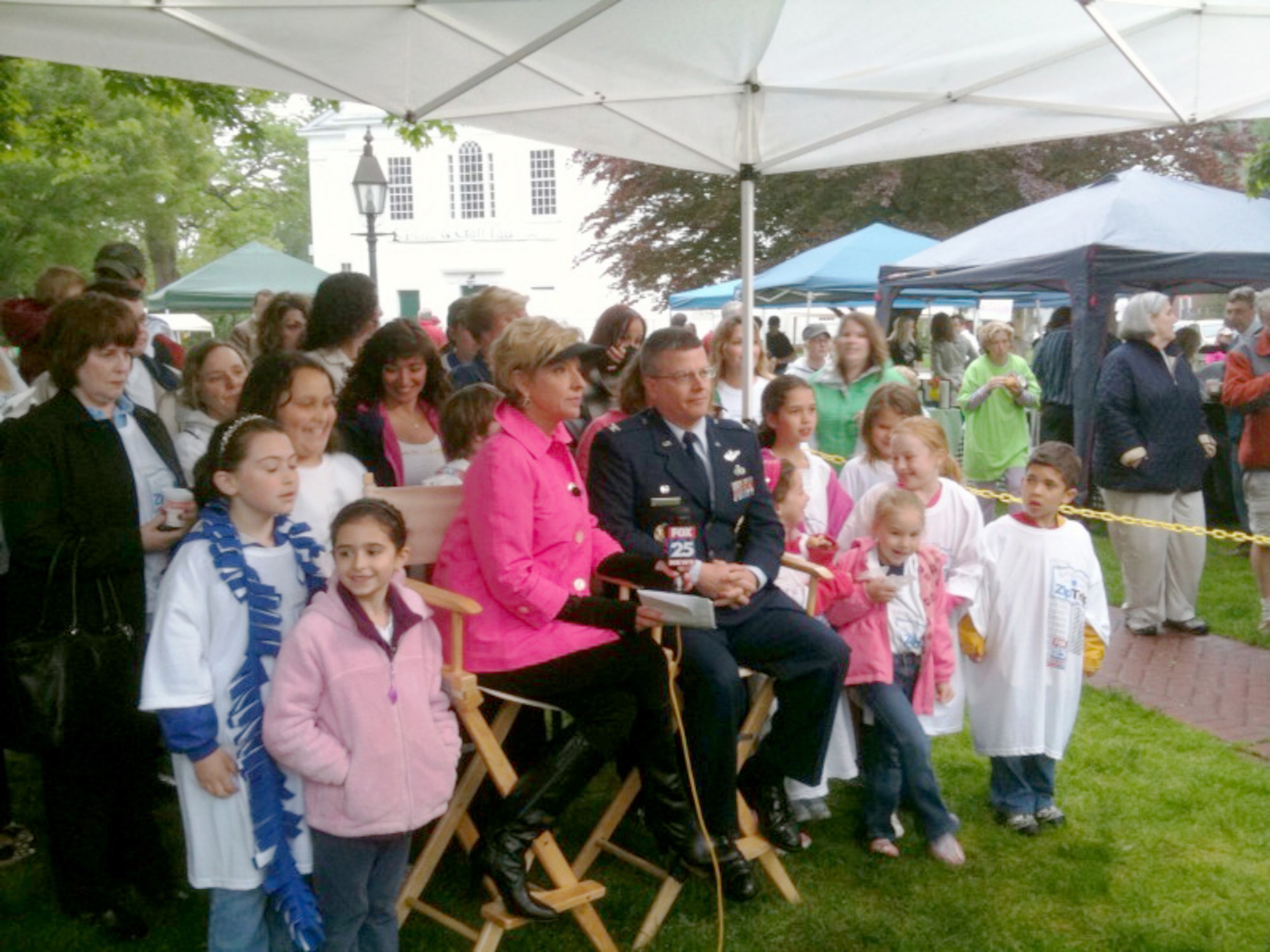 Col. Charles Thompson, 66th Air Base Wing commander, chats live with Boston's Fox 25 morning anchor Kim Carrigan on Bedford Common May 14.  The local channel was highlighting Bedford on it's weekly Zip Trip feature, and recognized Hanscom as a "community within a community." (U.S. Air Force photo by Kevin Gilmartin)