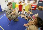 Staff Sgt. Jennifer Bynum, 559th Aerospace Medicine Squadron, reads the book "Hush" to a group of children at the Lackland Child Development Center May 11. Base Airmen performed readings for numerous groups of children at the Lackland and Gateway CDCs in support of Asian-American Heritage Month. (U.S. Air Force photo/Robbin Cresswell)