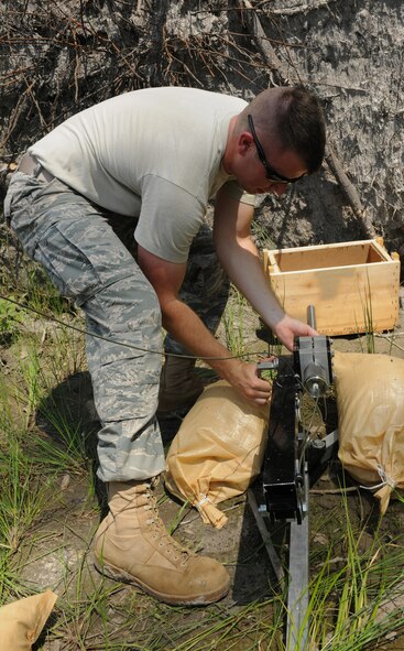 MOODY AIR FORCE BASE, Ga. -- Staff Sgt. Kyle Miller, 23rd Equipment Maintenance Squadron munitions craftsman, lines the percussion actuated neutralizer device up with the target during training here May 12. The 23rd Civil Engineer Squadron explosive ordnance disposal flight was helping prepare Sergeant Miller for school to become a member of EOD. (U.S. Air Force photo by Airman 1st Class Benjamin Wiseman/RELEASED)