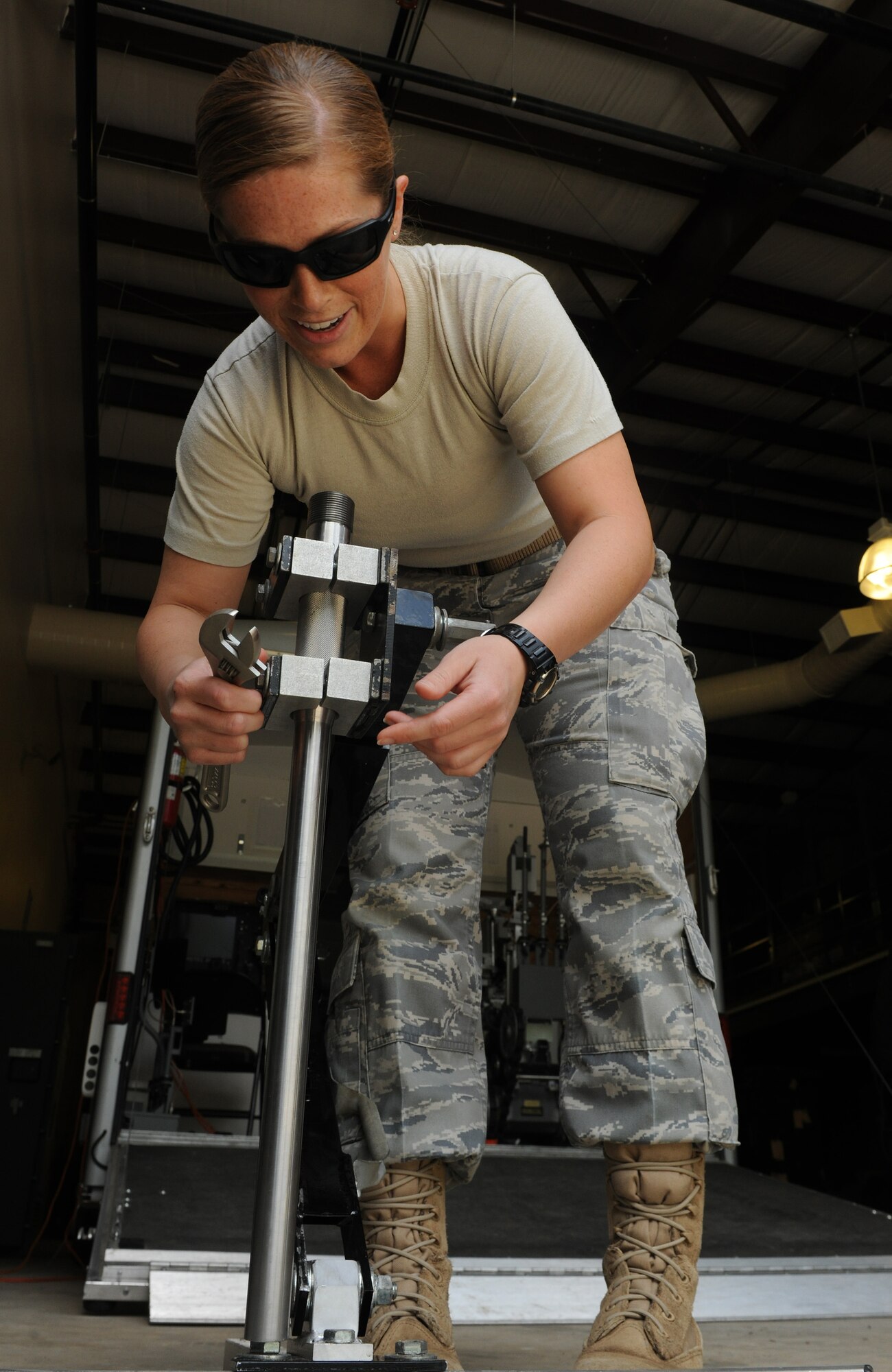 MOODY AIR FORCE BASE, Ga. -- Airman 1st Class Roxanna Shaw, 23rd Civil Engineer Squadron explosive ordnance disposal flight apprentice, tightens a percussion actuated neutralizer device onto a stand before training here May 12. The PAN device is used to disrupt circuitry on improvised explosive devices found by EOD members. (U.S. Air Force photo by Airman 1st Class Benjamin Wiseman/RELEASED)