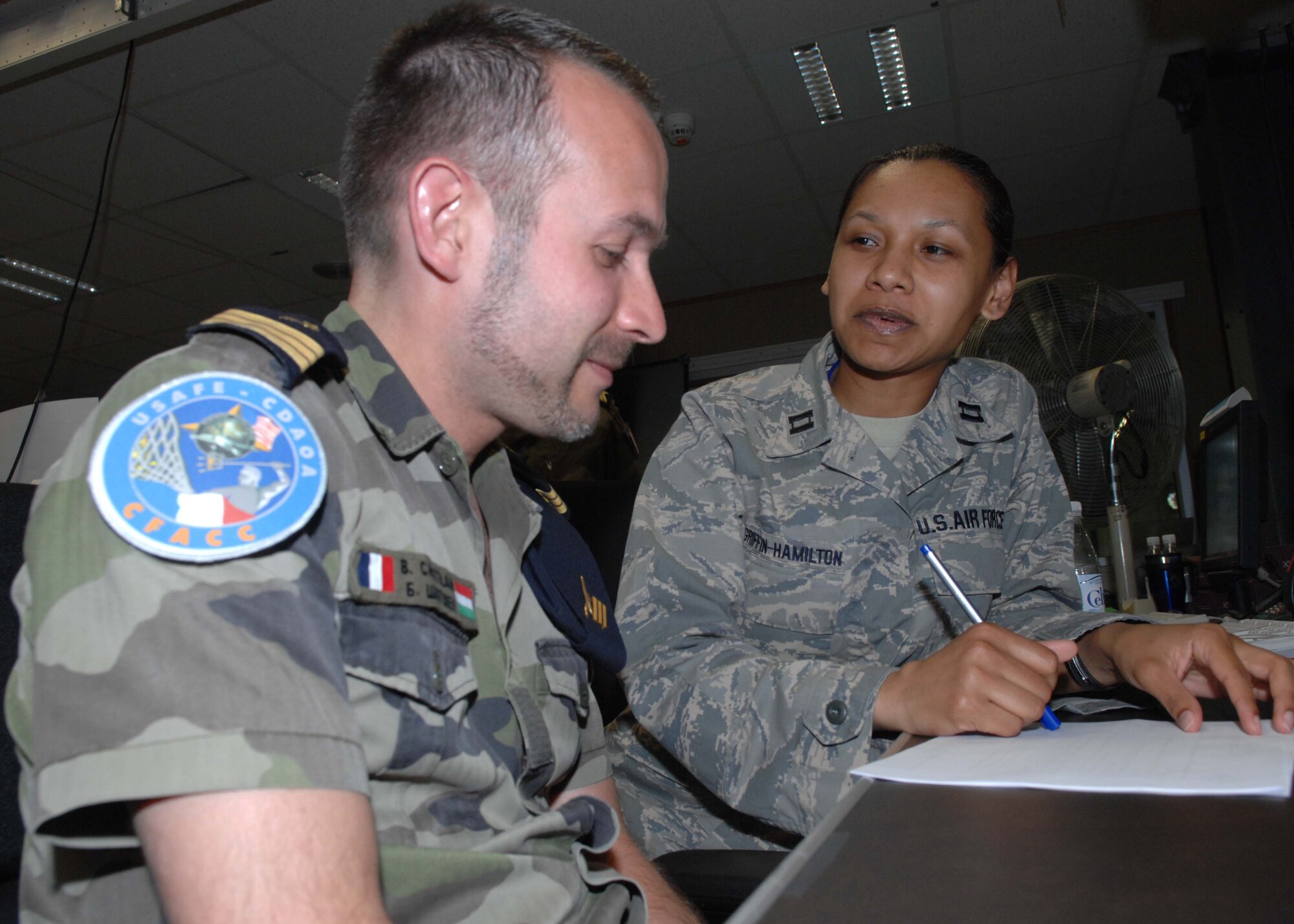 Einsiedlerhof Air Station, Germany--Capt. Montana Griffin-Hamilton discusses scenarios with French Air Force Capt. Brice Chatelain during the U.S. European Command's premier exercise. The exercise brought together U.S., French, and Polish forces as part of a combined task force.  (U.S. Air Force photo by Senior Airman Kirsten Sisson)
