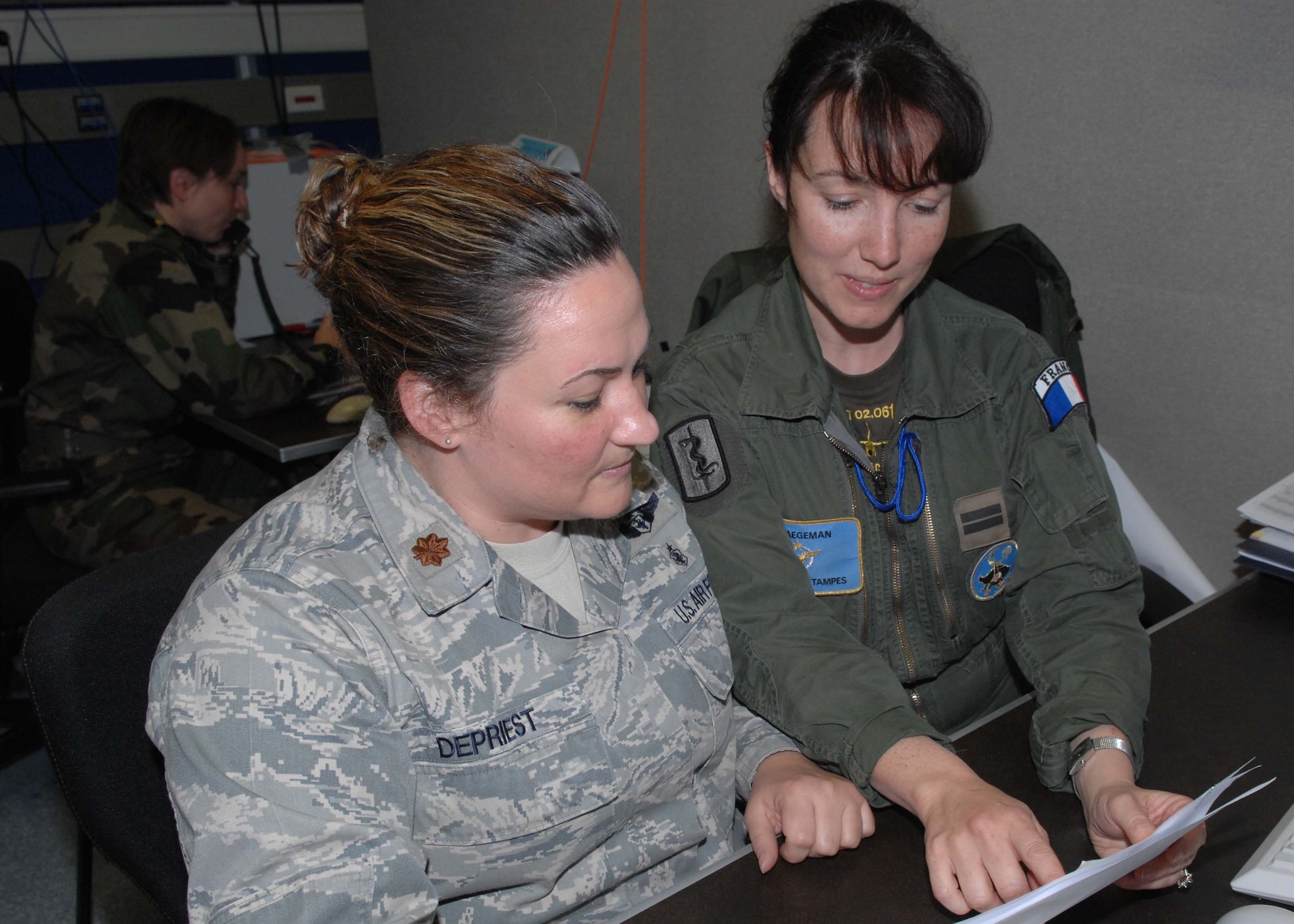 Eisiedlerhof Air Station, Germany--French Air Force 1st Lt. Emmanuelle Waegeman provides Maj. Dawn DePriest with an operational update during the U.S. European Command's premier exercise.  The exercise united U.S., French, and Polish forces as part of a combined task force. (U.S. Air Force photo by Senior Airman Kirsten Sisson)  