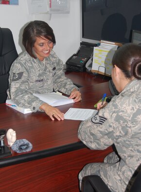 U.S. Air Force Tech. Sgt. Amanda Hendrix, 386th Air Expeditionary Wing Legal office paralegal, goes over a power of attorney form with a customer May 10, 2010 at an air base in Southwest Asia. Sergeant Hendrix is a Farmington, N.M. native, deployed from MacDill Air Force Base, Fla. (U.S. Air Force photo by Capt. Joe Campbell/Released)