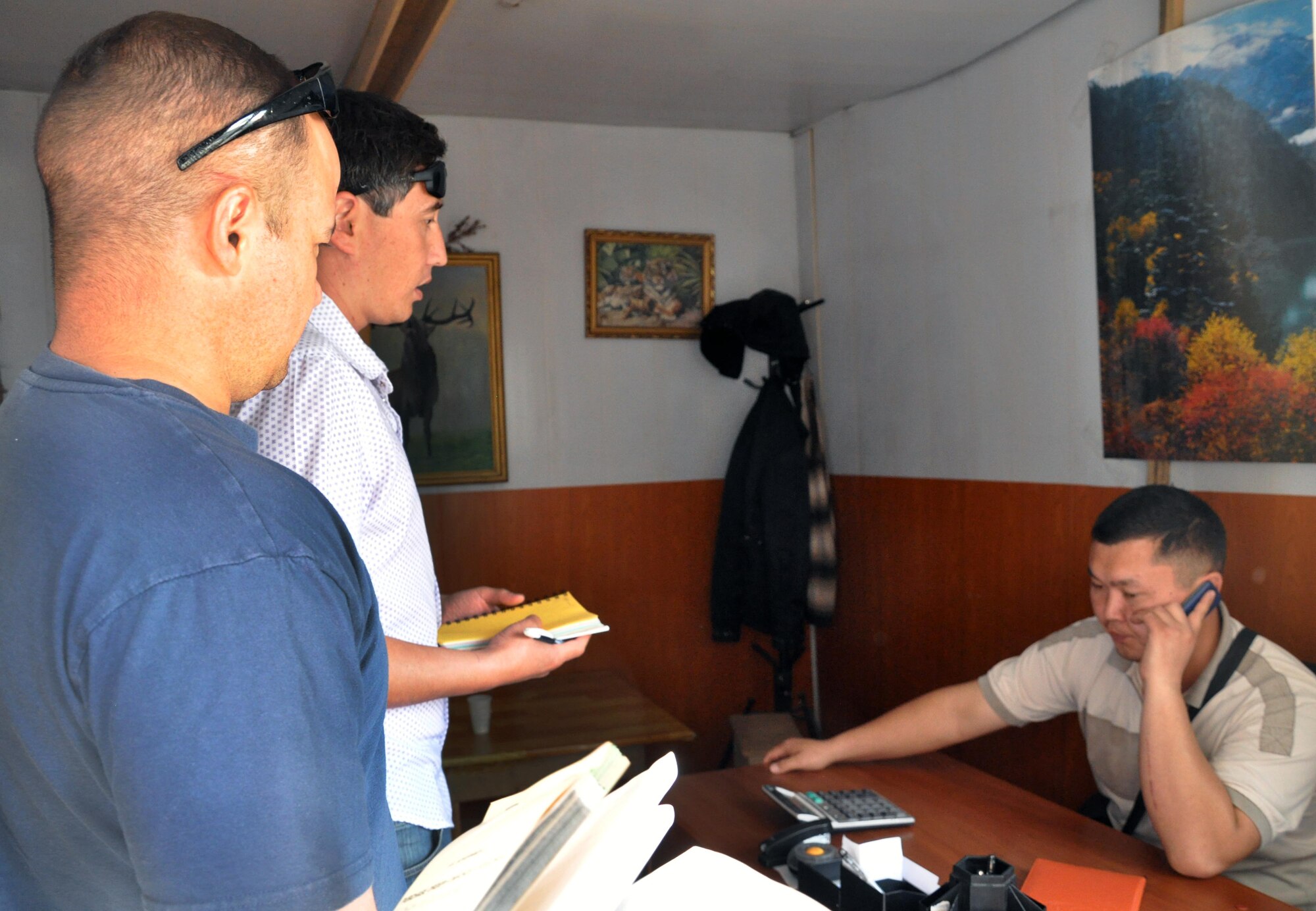 Master Sgt. Freddy Andrews, left, interacts with a local employee who specializes in flooring with the help of an interpreter May 13, 2010, in a local market outside the Transit Center at Manas, Kyrgyzstan. Sergeant Andrews is the 376th Expeditionary Civil Engineer Squadron quality assurance flight chief, and his team of six regularly does CE-related humanitarian assistance all over northern Kyrgyzstan. (U.S. Air Force photo/Staff Sgt. Carolyn Viss)
