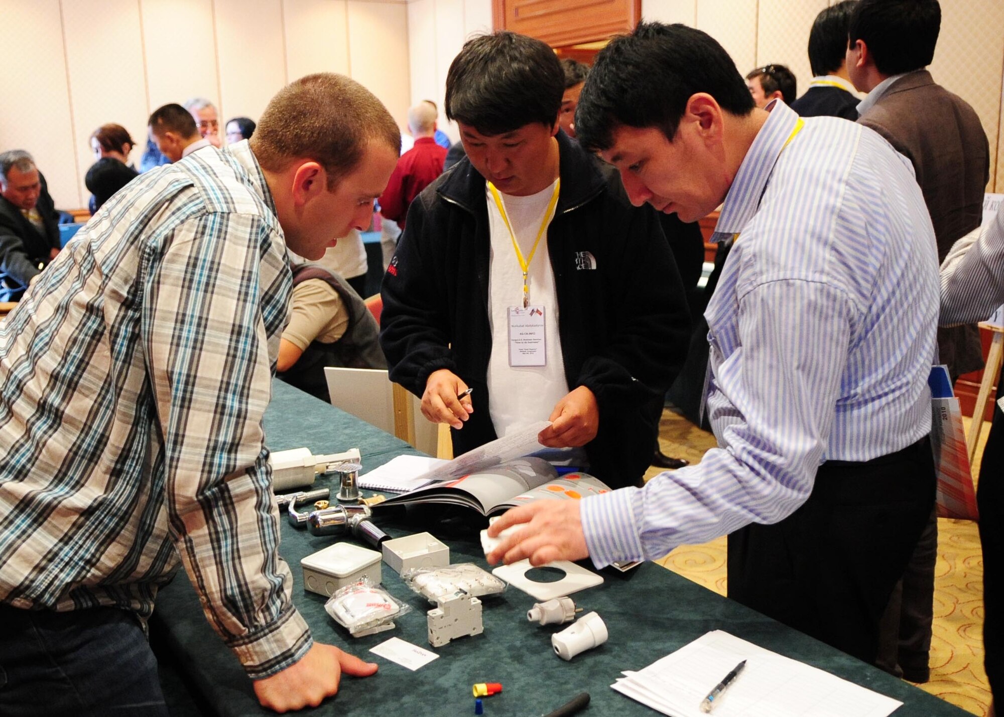Senior Airman Alan Ruppe, a 376th Expeditionary Civil Engineer Squadron operations support quality assurance specialist, speaks with Kyrgyz business professionals about what products the Transit Center is seeking to acquire locally during a "How to Do Business" procurement seminar at the Hyatt Regency in Bishkek, Kyrgyzstan, May 8, 2010. His team of six regularly does CE-related humanitarian assistance all over northern Kyrgyzstan.  (U.S. Air Force photo/ Senior Airman Nichelle Anderson/ released)