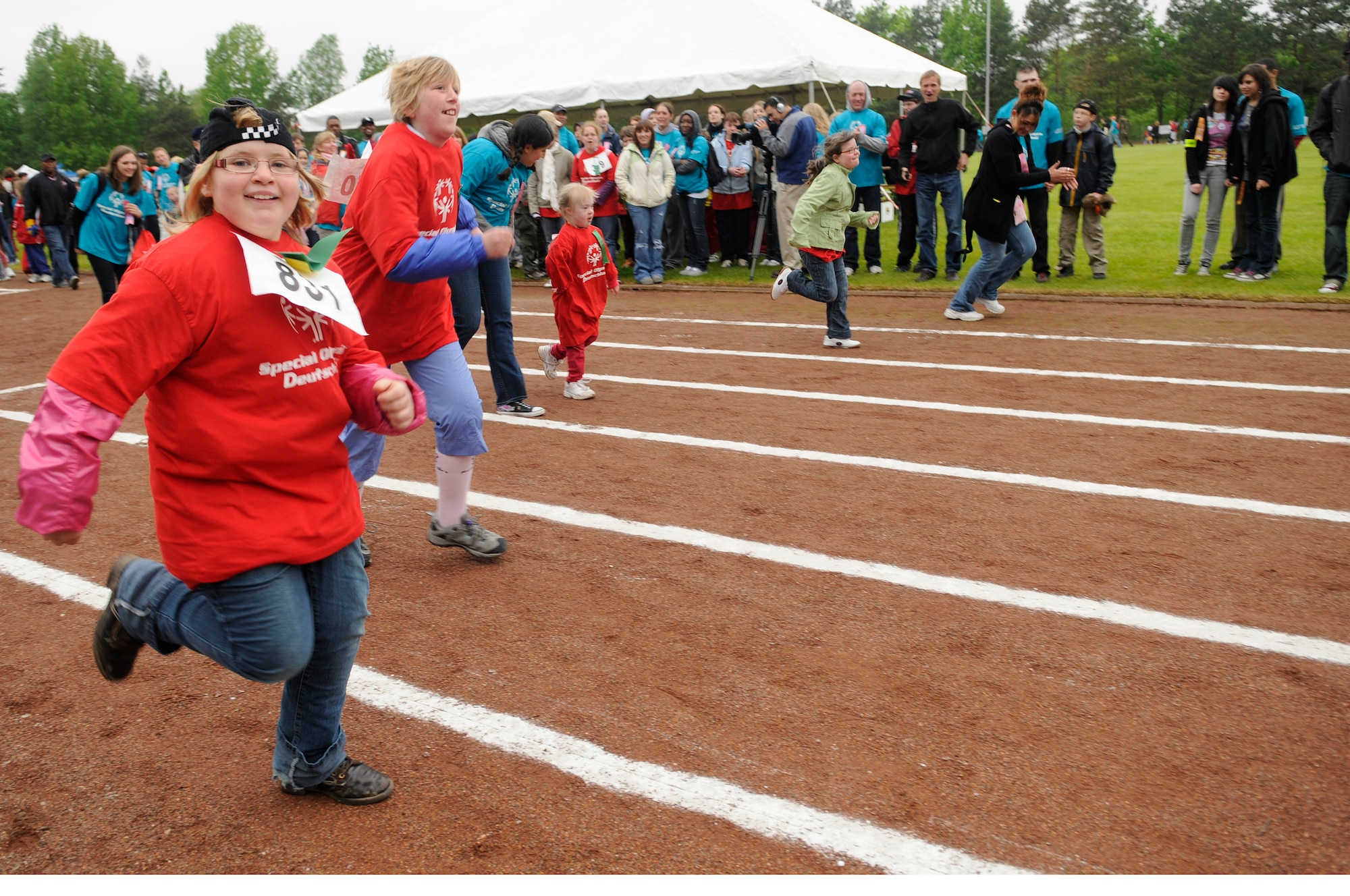 Athletes and their buddies race at the Special Olympics held in Enkenbach-Alsenborn, Germany, May 12, 2010. Special Olympics is a worldwide event for children and adults with disabilities to build confidence and foster friendship. The Kaiserslautern Military Community hosted its 27th Annual Special Olympics for over 800 athletes. (U.S. Air Force photo by Airman 1st Class Desiree Esposito)