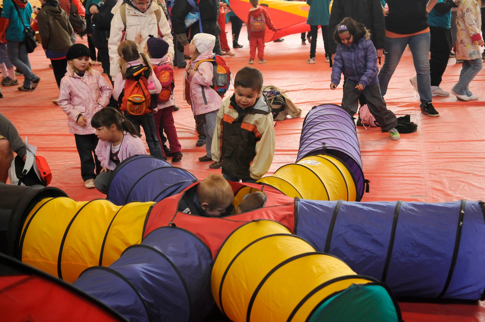 Children crawl through a worm tunnel during the Special Olympics held in Enkenbach-Alsenborn, Germany, May 12, 2010. Special Olympics is a worldwide event for children and adults with disabilities to build confidence and foster friendship. The Kaiserslautern Military Community hosted its 27th Annual Special Olympics for over 800 athletes. (U.S. Air Force photo by Airman 1st Class Desiree Esposito)