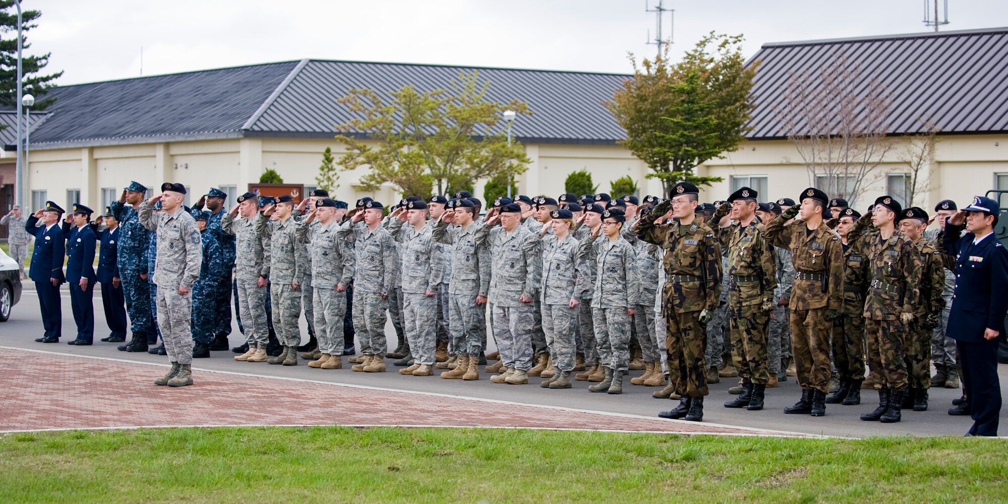 Members of the 35th Security Forces Squadron and Naval Air Facility Security along with personnel from the Japan Air Self-Defense Force Transportation and Security Misawa City Police Station take part in a retreat ceremony May 14 to honor law enforcement professionals who were killed in the line of duty. The ceremony marked the end of National Police Week and also served as a chance to strengthen bonds among the various security and police agencies of the surrounding area. (U.S. Air Force photo/Senior Airman Jamal D. Sutter)