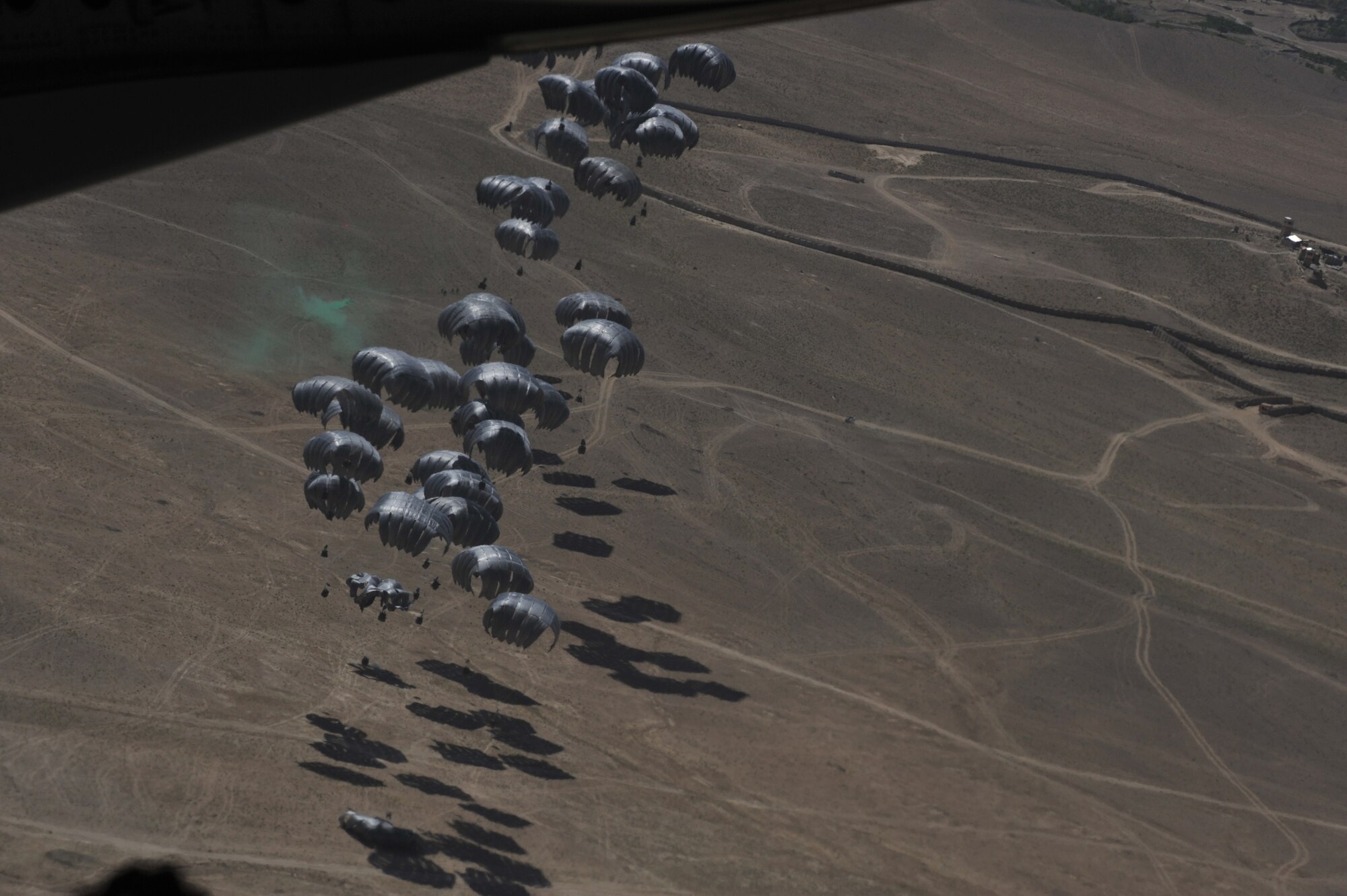 Container delivery System bundles float down to a marked area after being air dropped from a C-17 Globemaster III over Afghanistan, April 5, 2010.  The CDS bundles are filled with food and water to re-supply U.S. Forces.  (U.S. Air Force photo/Staff Sgt. Quinton Russ/released)