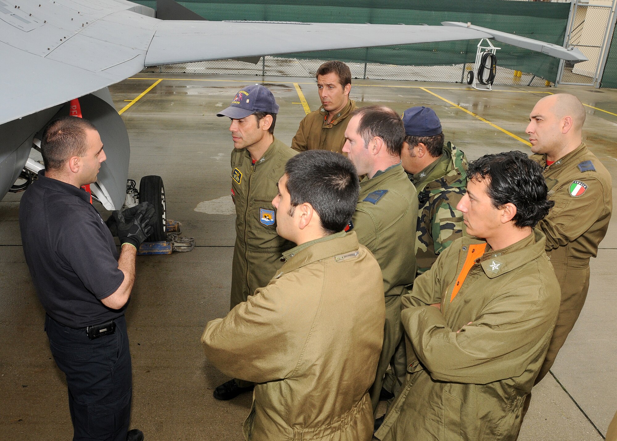 Mr. Fabrizio La Marca, 31st Civil Engineer Squadron firefighter, shows Italian air force firefighters from Rivolto Airport the locations of safety pins on an F-16 Fighting Falcon May 10 as part of an annual F-16 emergency response action training.  In case of an in-flight emergency and Aviano pilots need to land at the Rivolto airport, the firefighters there must respond to the incident properly to ensure the safety of everyone involved.  (U.S. Air Force photo/ Senior Airman Tabitha M. Mans)