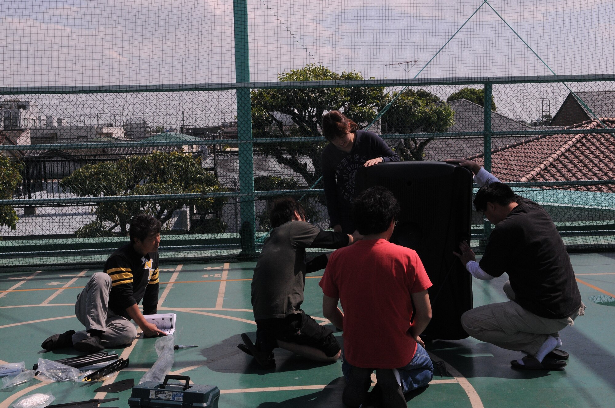 YOKOTA AIR BASE, Japan -- Employees at the Aiji no Ie orphanage work together to put up a basketball stand for the children to play with.  Aiji no Ie translated means House of Affection. The orphanage has 36 children ranging in ages from 2 to 17. (U.S. Air Force photo/ Airman 1st Class Lynsie Lorenz)