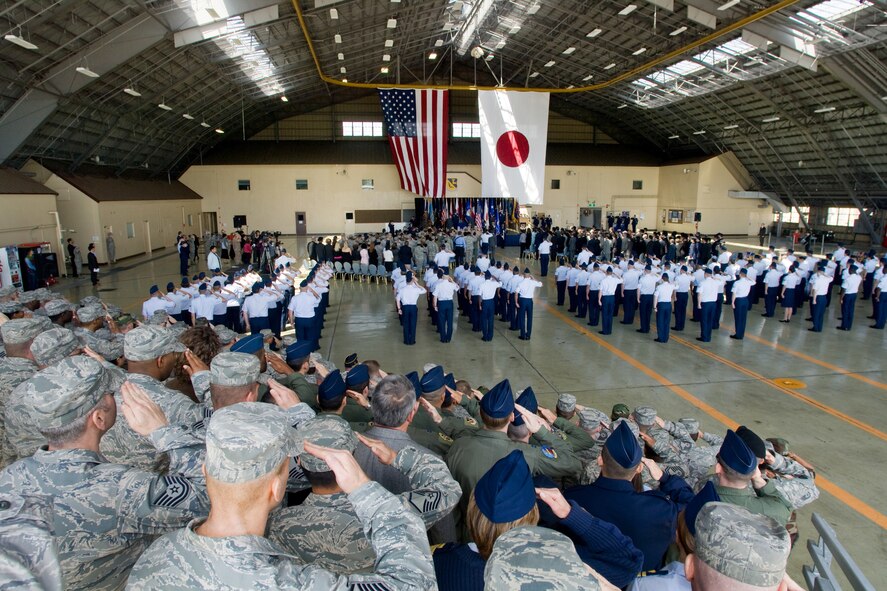 YOKOTA AIR BASE, Japan -- Yokota servicemembers salute during the 374th Airlift Wing change of command ceremony here May 14. In attendance were members of Yokota, the local community and Japan Self-Defense Forces. (U.S. Air Force photo/Osakabe Yasuo)