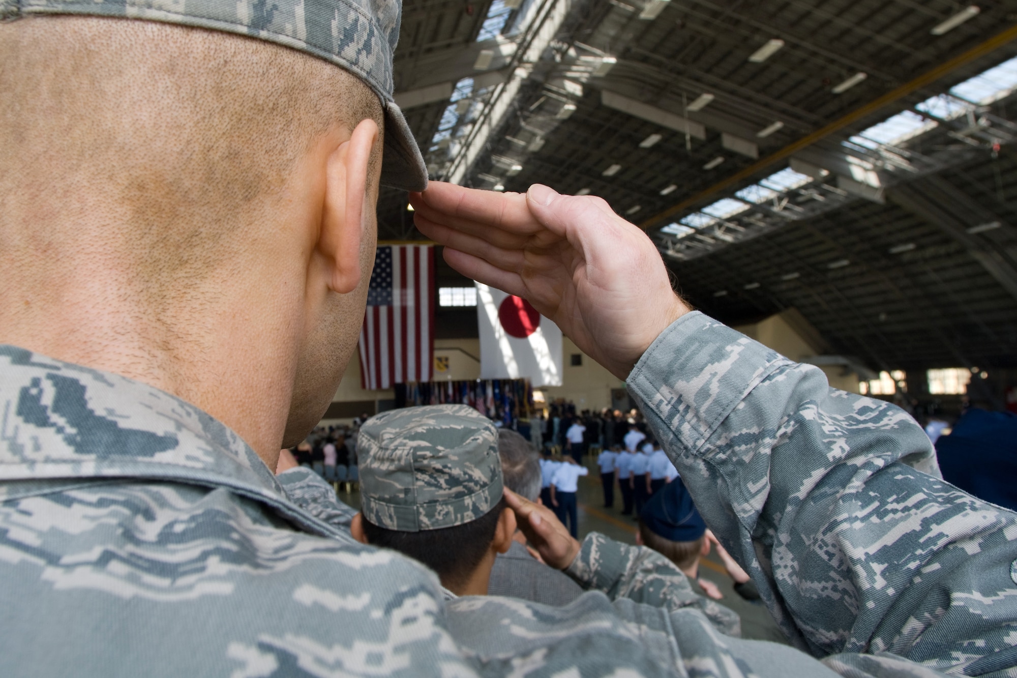 YOKOTA AIR BASE, Japan -- Yokota servicemembers salute during the 374th Airlift Wing change of command ceremony here May 14. In attendance were members of Yokota, the local community and Japan Self-Defense Forces. (U.S. Air Force photo/Osakabe Yasuo)