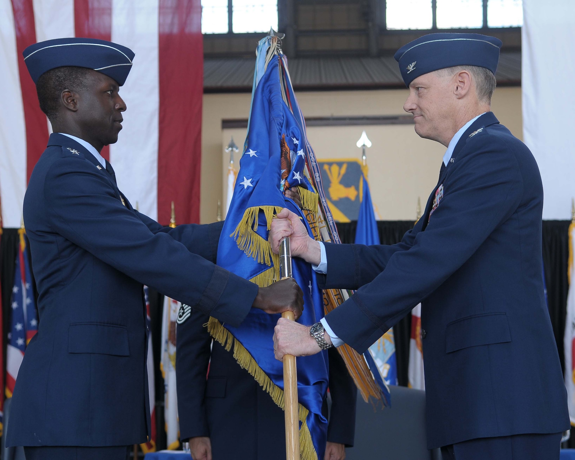 YOKOTA AIR BASE, Japan -- Lt. Gen. Edward Rice Jr., commander United States Forces Japan and 5th Air Force, passes the guidon to Col. Otto Feather, 374th Airlift Wing commander, May 14 during the 374th Airlift Wing change of command. (U.S. Air Force photo/Airman 1st Class Sean Martin)