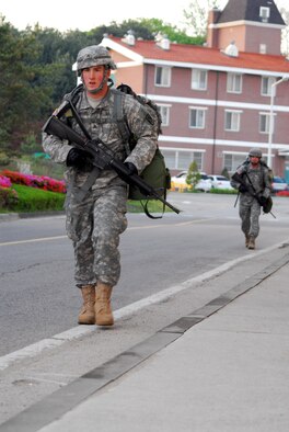 Sgt. Cody Thorington and Sgt. Sean McSherry march with 35-pound ruck sacks through the 12-mile course of the competition throughout Osan Air Base, May. 7. (U.S. Army photo/Pfc. Michael Vanpool)