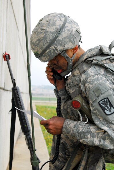 Cpl. Choi, Bing Su calls for a medical evacuation during the warrior tasks portion of the competition at the Battery C, 6-52 AMD tactical site May. 6. (U.S. Army photo/Sgt. Scott Smith)