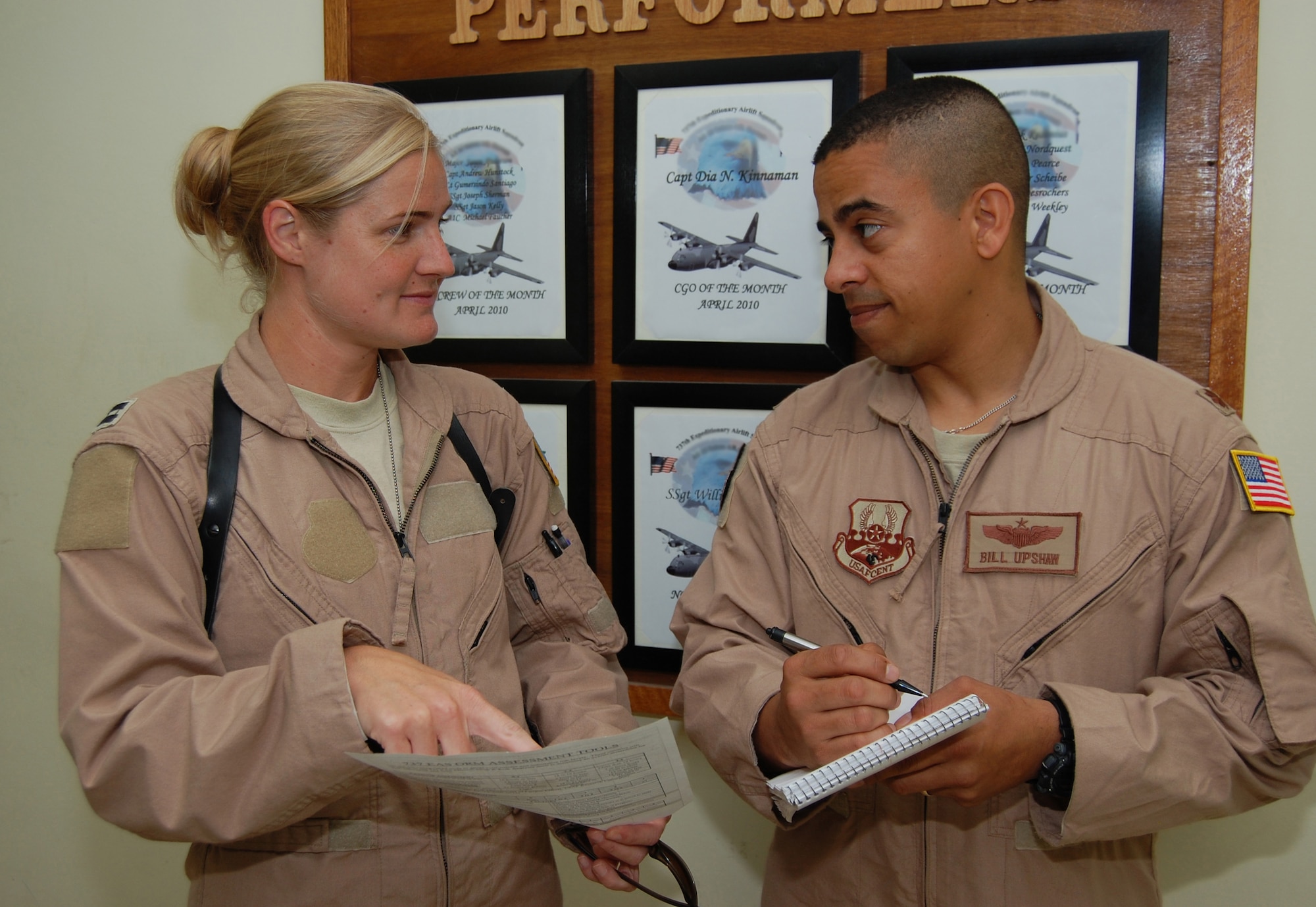 From right, U.S. Air Force Maj. Bill Upshaw, 386th Air Expeditionary Wing Flight Safety chief, discusses operational risk management techniques with Capt. Nancy Badgett, 737th Expeditionary Airlift Squadron C-130 pilot May 12, 2010 at an air base in Southwest Asia. (U.S. Air Force photo illustration by Staff Sgt. Lakisha A. Croley/Released)