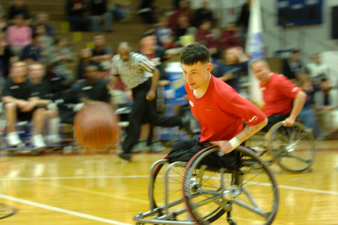 U.S. Marine Corps Cpl. Raymond Hennagir chases down a loose ball during the gold medal game for wheelchair basketball at the U.S. Olympic Training Center in Colorado Springs, Colo., May 13, 2010. The Marines won gold, defeating Army 44-15. The game was part of the inaugural Warrior Games.