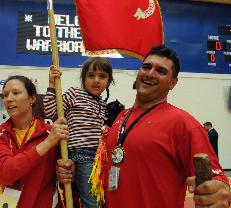 U.S. Marine Sgt. Michael Blair, All-Marine Warrior Games Team athlete and Maj. Susan Stark, All-Marine Warrior Games Team head coach, celebrate the Marines Corps’ gold medal victory in sitting volleyball with Blair’s 4-year-old daughter, Bella, at the U.S. Olympic Training Center in Colorado Springs, Colo., May 13, 2010. The Marines won the gold medal defeating the Army 15-9 in the last game of a best-out-of-three championship.