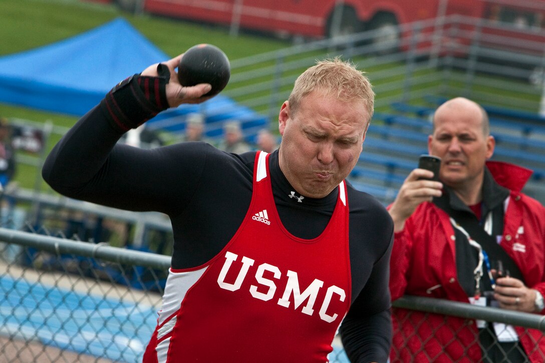 U.S. Marine Corps Cpl. Travis Greene with the Marine Warrior Team throws a shot put during the finals of the inaugural Warrior Games track and field events at the United States Air Force Academy, in Colorado Springs, Colo., May 14, 2010. Greene won the silver medal in the sitting shot put competition with a distance of 22.5 feet.