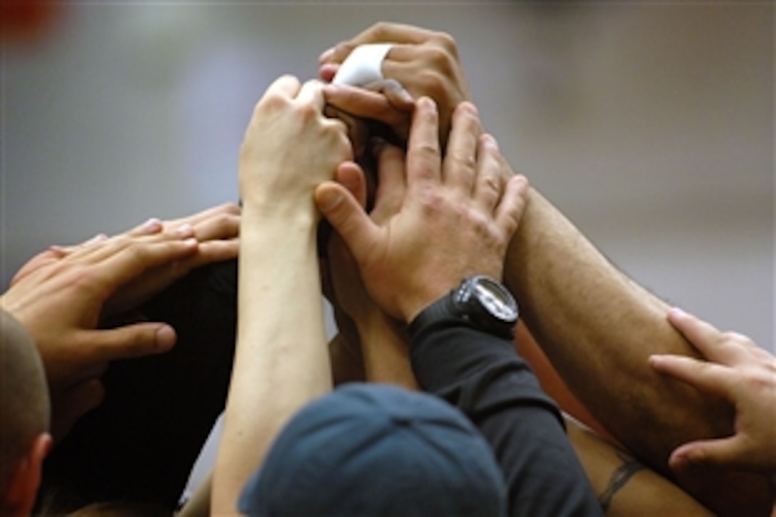 Army sitting volleyball teammates rally in an attempt to overcome the Marines in a gold medal match with the Marines at the Warrior Games in Colorado Springs, Colo. May 13, 2010. The Army lost the series to the Marines two games to one claiming the silver medal. 