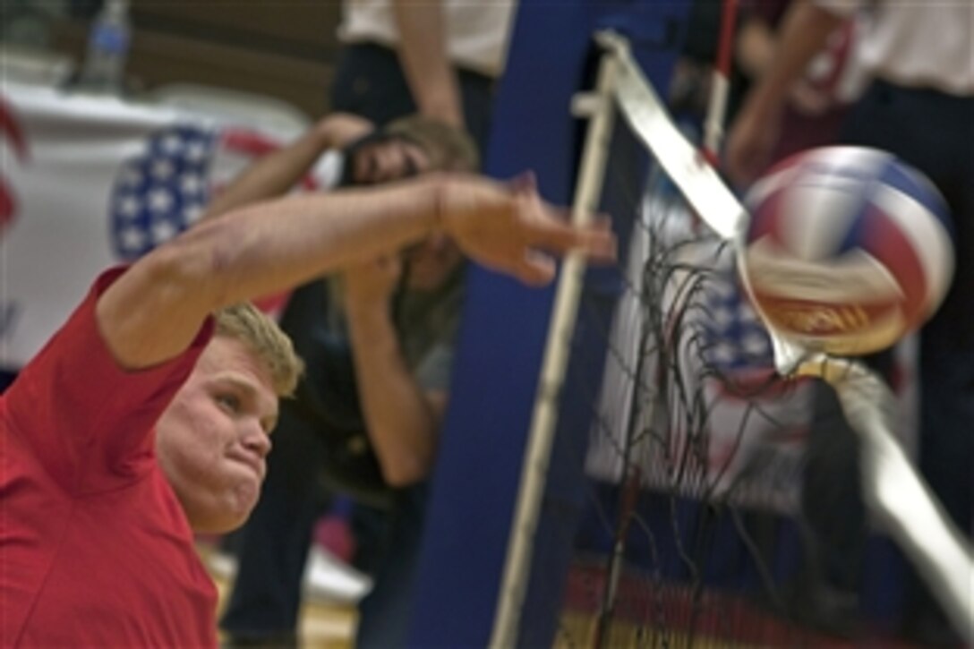 U.S. Marine Pfc. Jese Schag, 21, from Sheridan, Ill., spikes a volleyball against the Army team during the championship match of the inaugural Warrior Games' sitting volleyball competition, Colorado Springs, Colo., May 13, 2010. The Marines won the gold medal defeating the Army 15-9 in the last game of a best-out-of-three championship.  